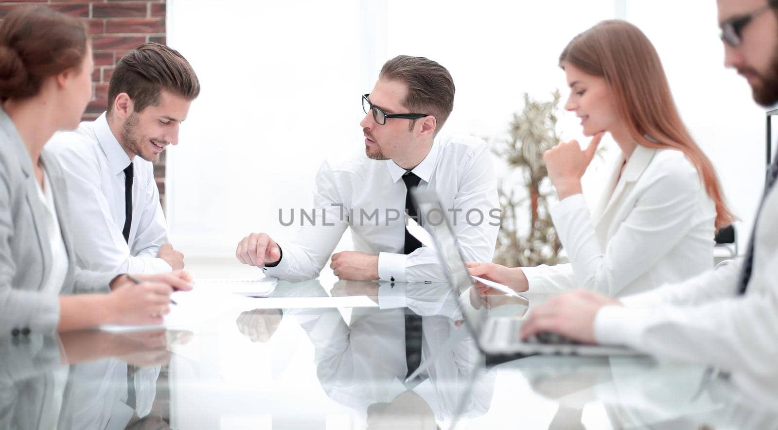 businessman talking with employees at a business meeting by asdf