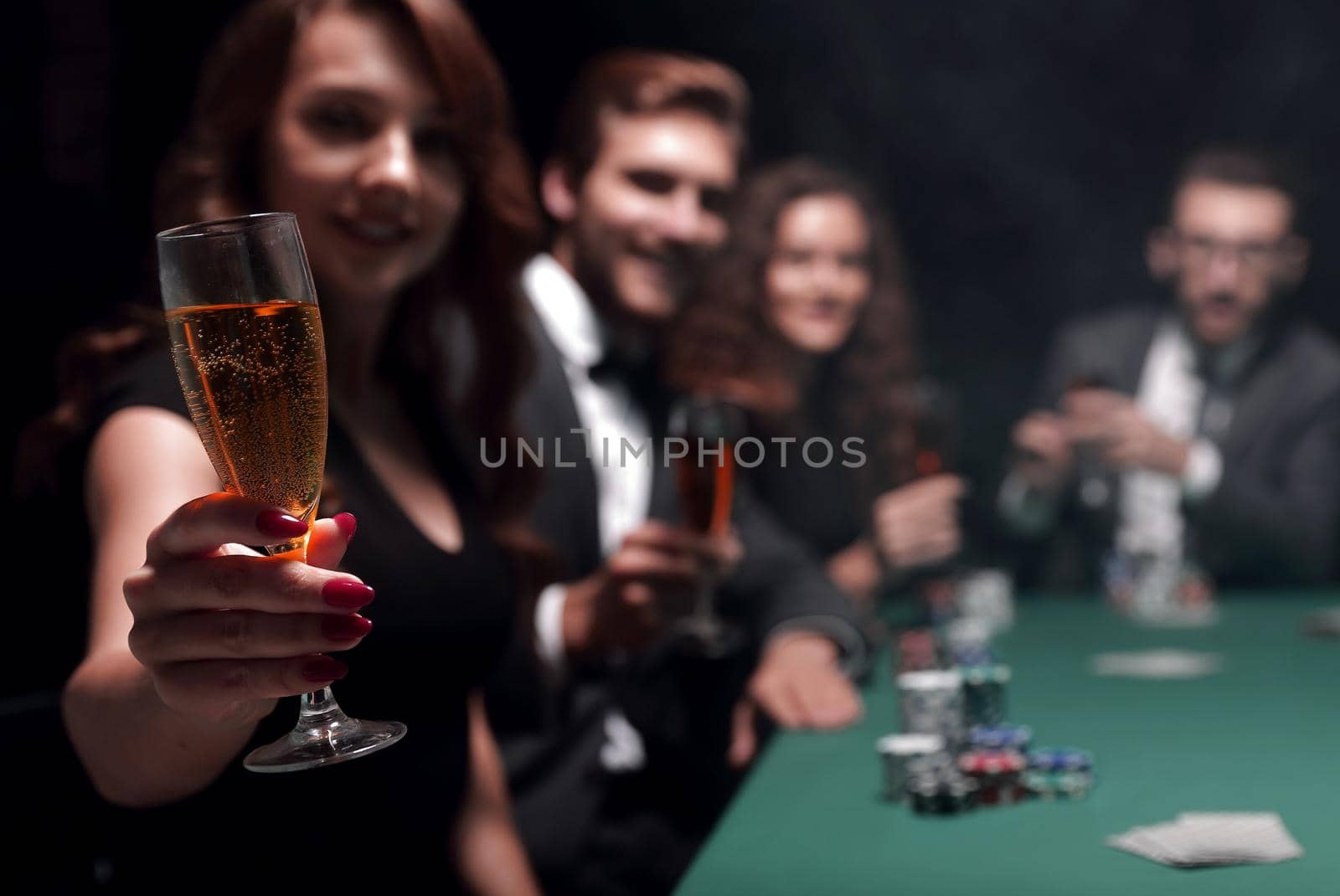 fashion woman with glasses of wine,sitting at a table in a casino by asdf