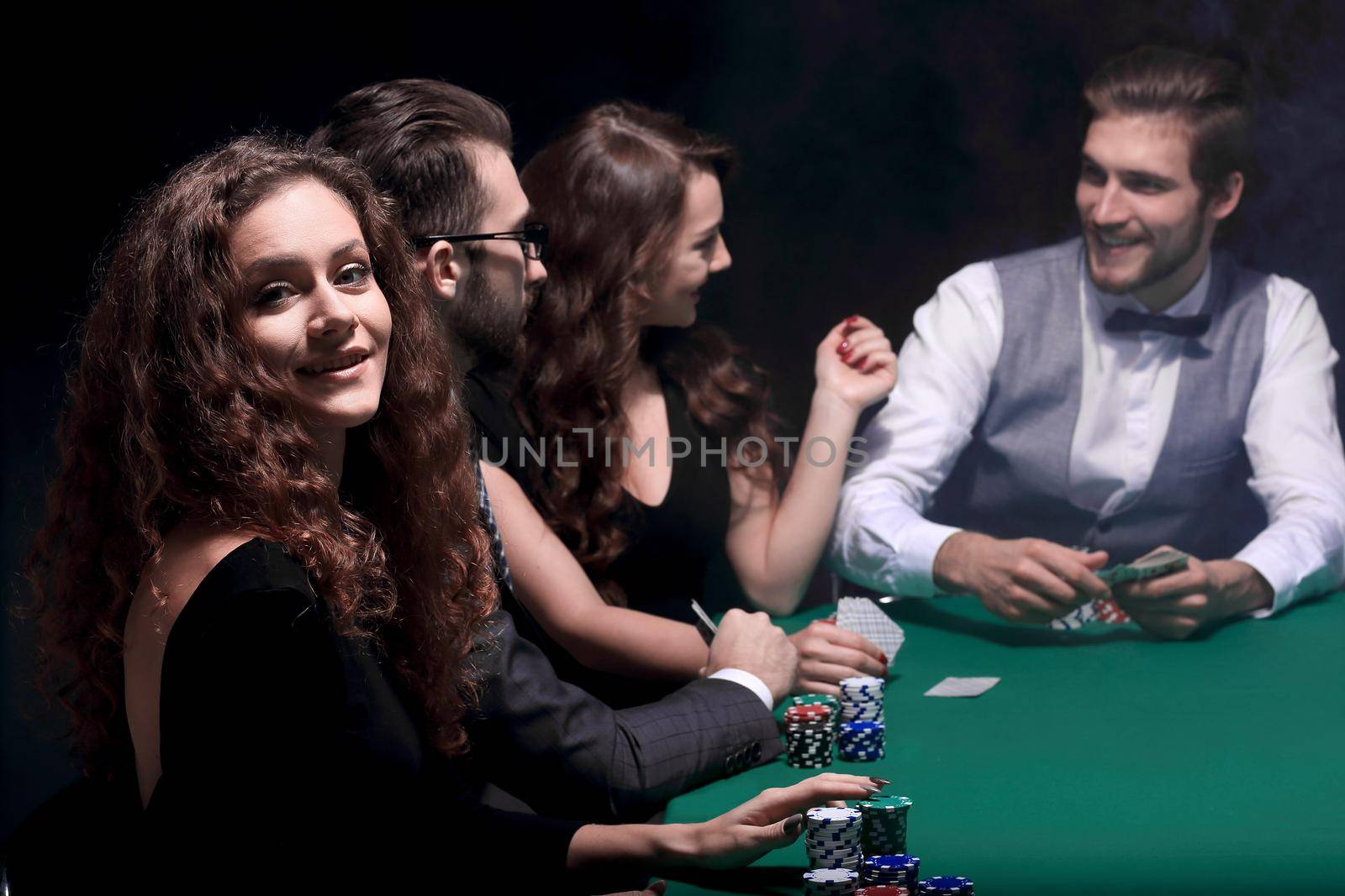 closeup.poker players sitting at a casino table . the concept of luck.