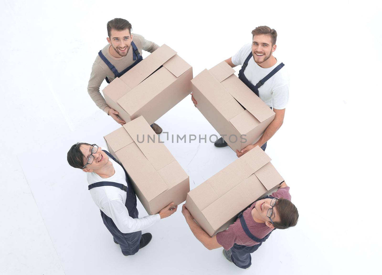 Movers lifting stack of cardboard moving boxes isolated on white