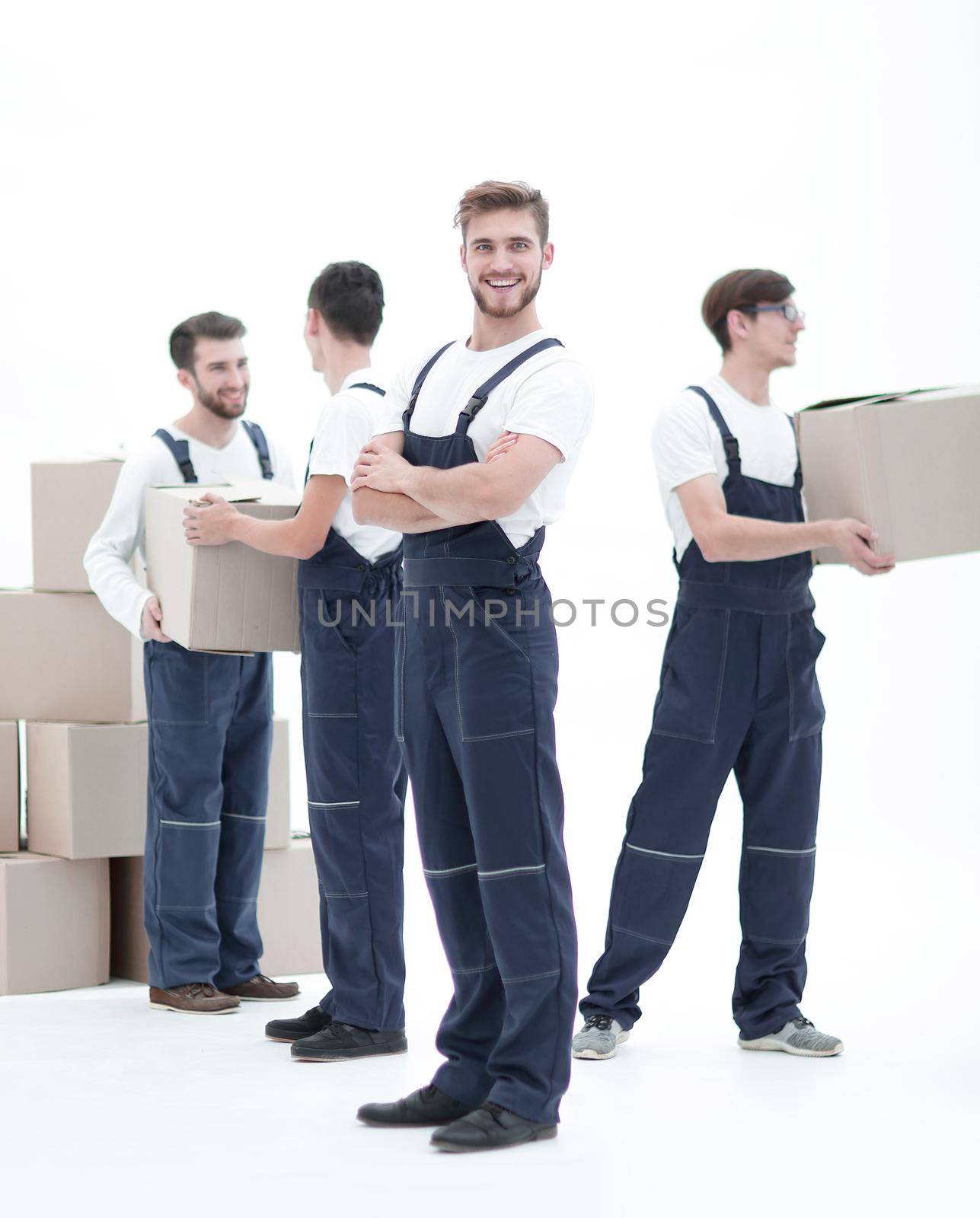 Photo workers pass each other boxes when moving flats.