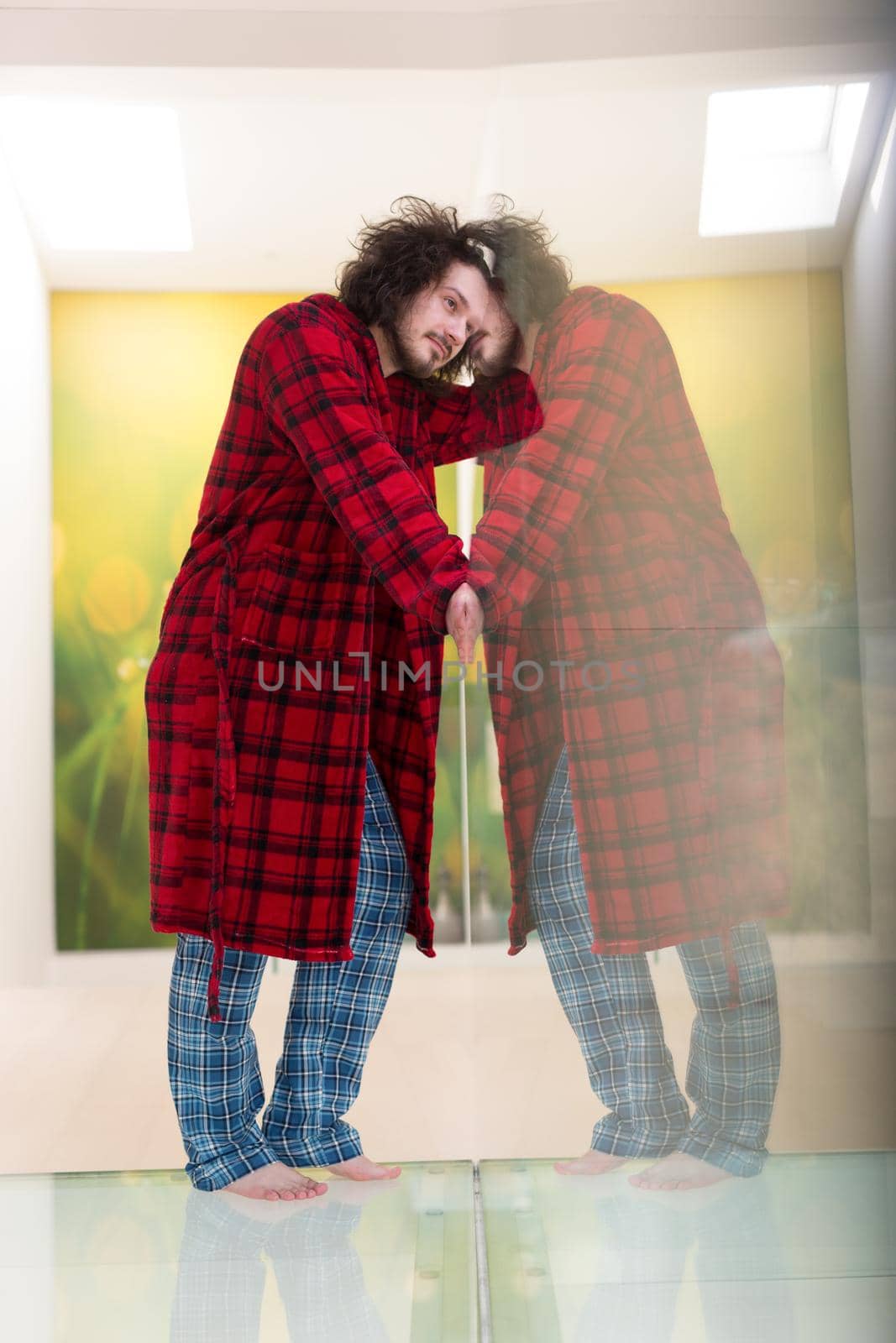 portrait of young man in bathrobe enjoying free time at home