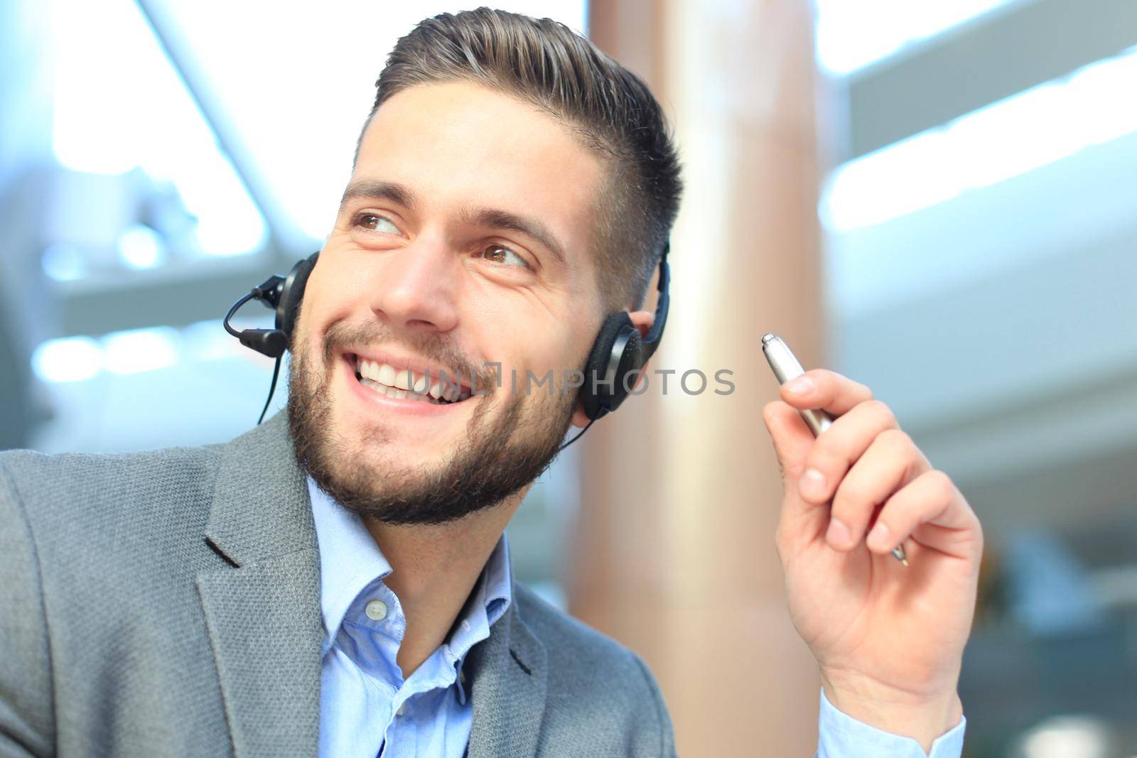 Smiling friendly handsome young male call centre operator