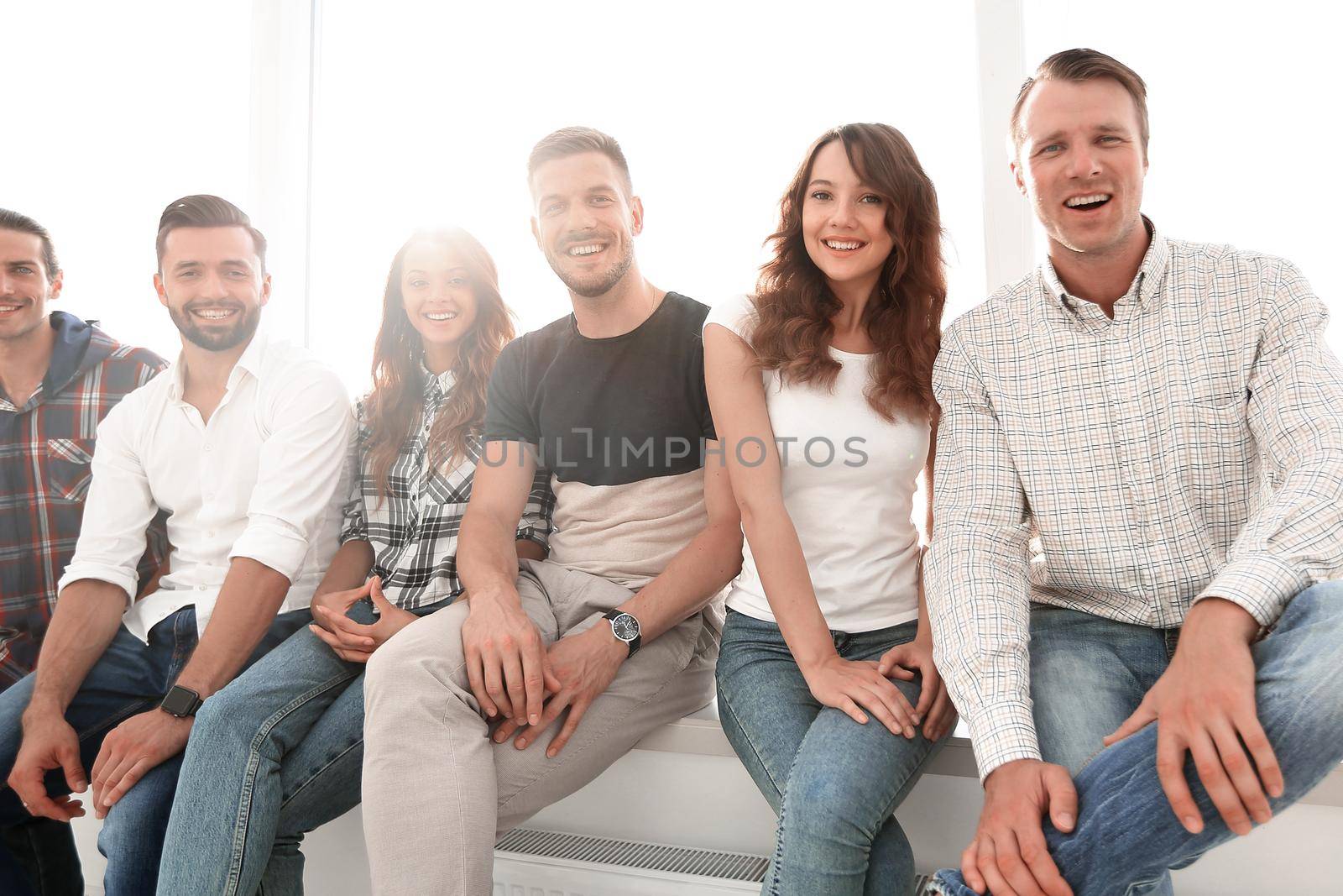 young creative people sitting on chairs in waiting room by asdf