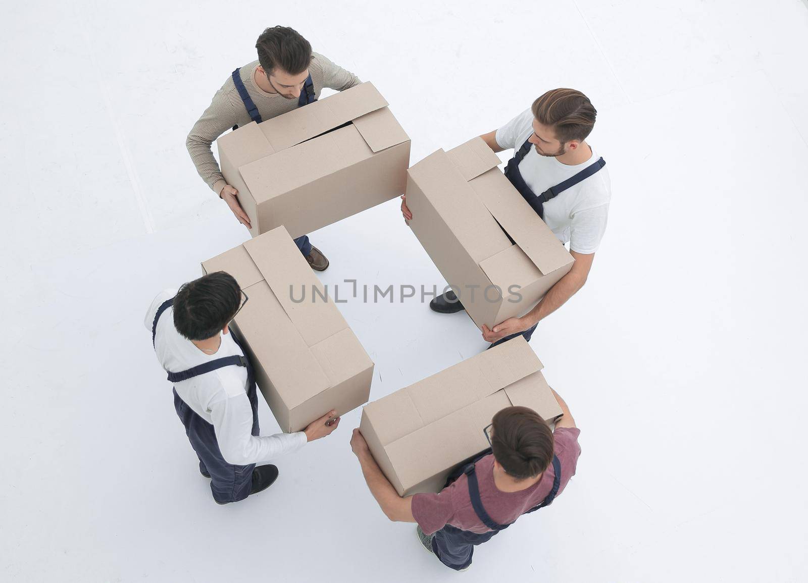 Movers lifting stack of cardboard moving boxes isolated on white