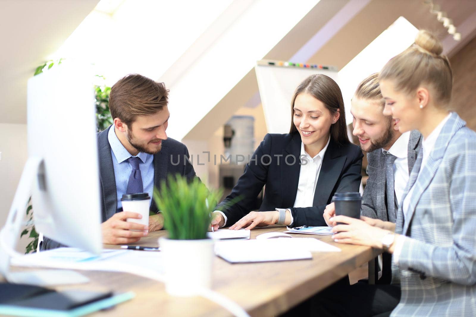 Group of business partners discussing strategies at meeting in office