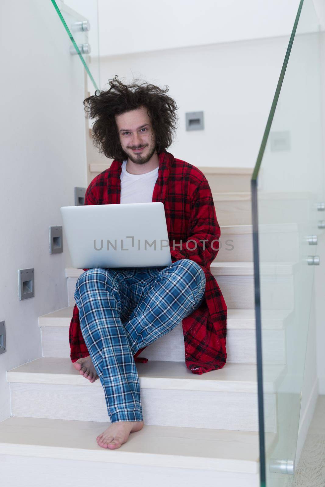 freelancer in bathrobe working from home by dotshock