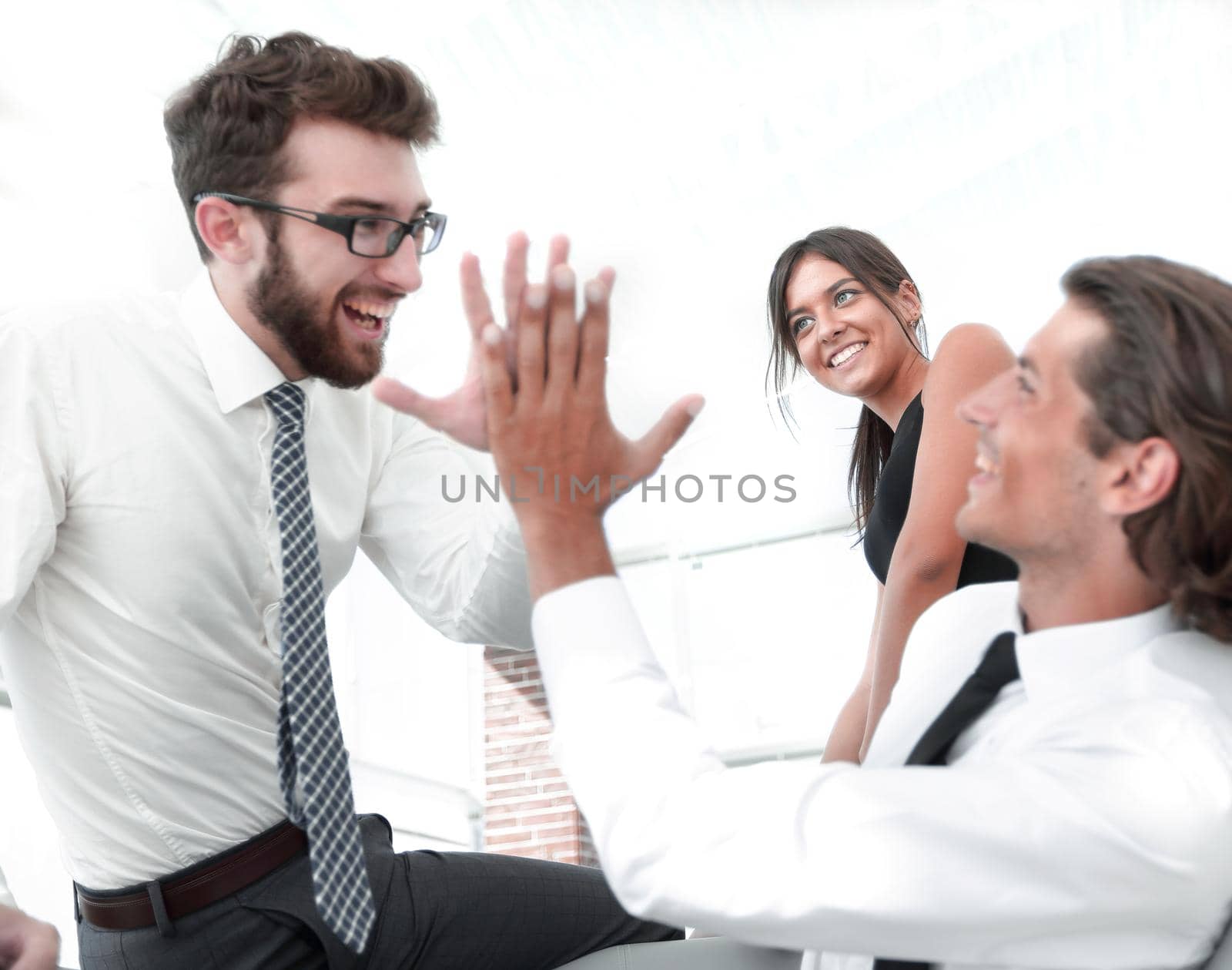 business colleagues giving each other high five. by asdf