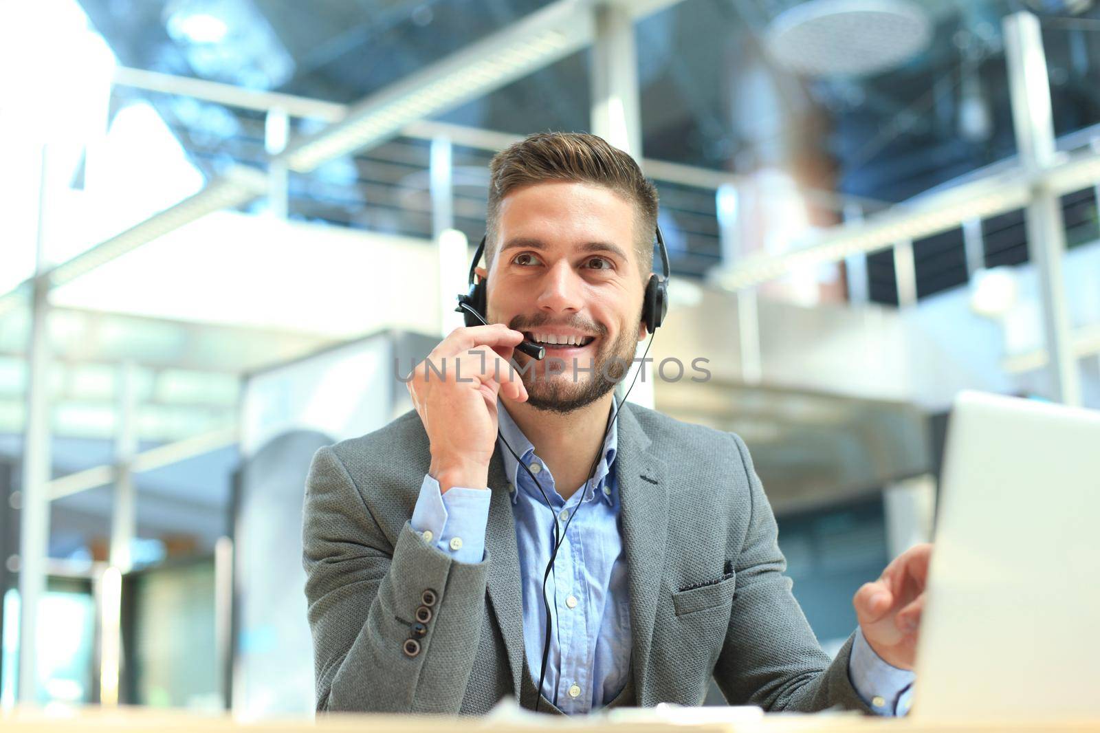 Smiling friendly handsome young male call centre operator