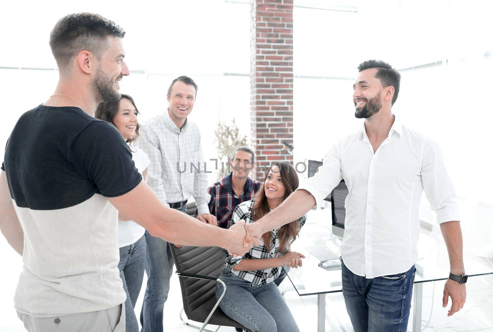 welcome handshake colleagues in creative office.photo with copy space