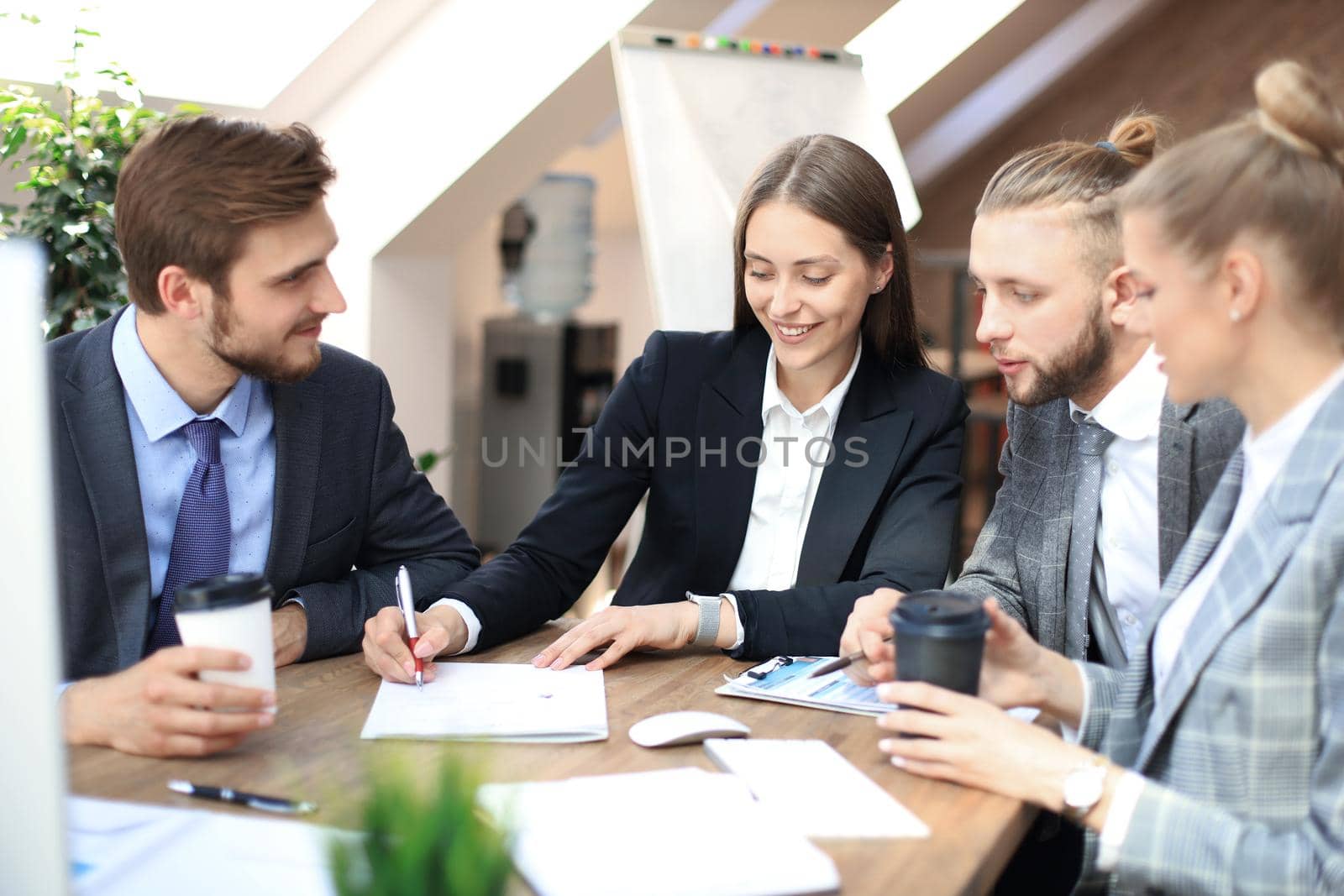 Group of business partners discussing strategies at meeting in office