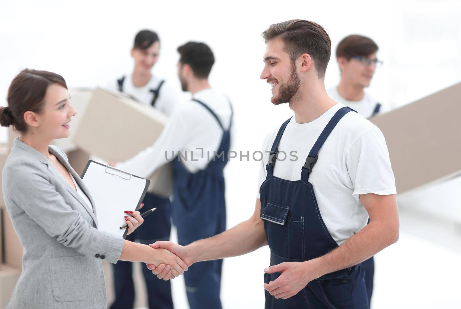 Manager with clipboard shaking hands with movers. by asdf