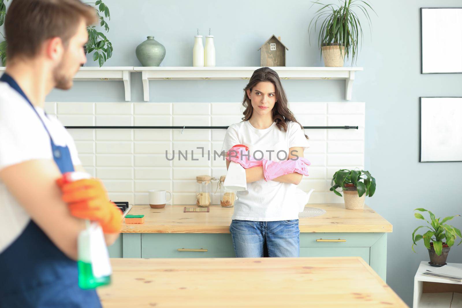Young couple at home doing hosehold chores