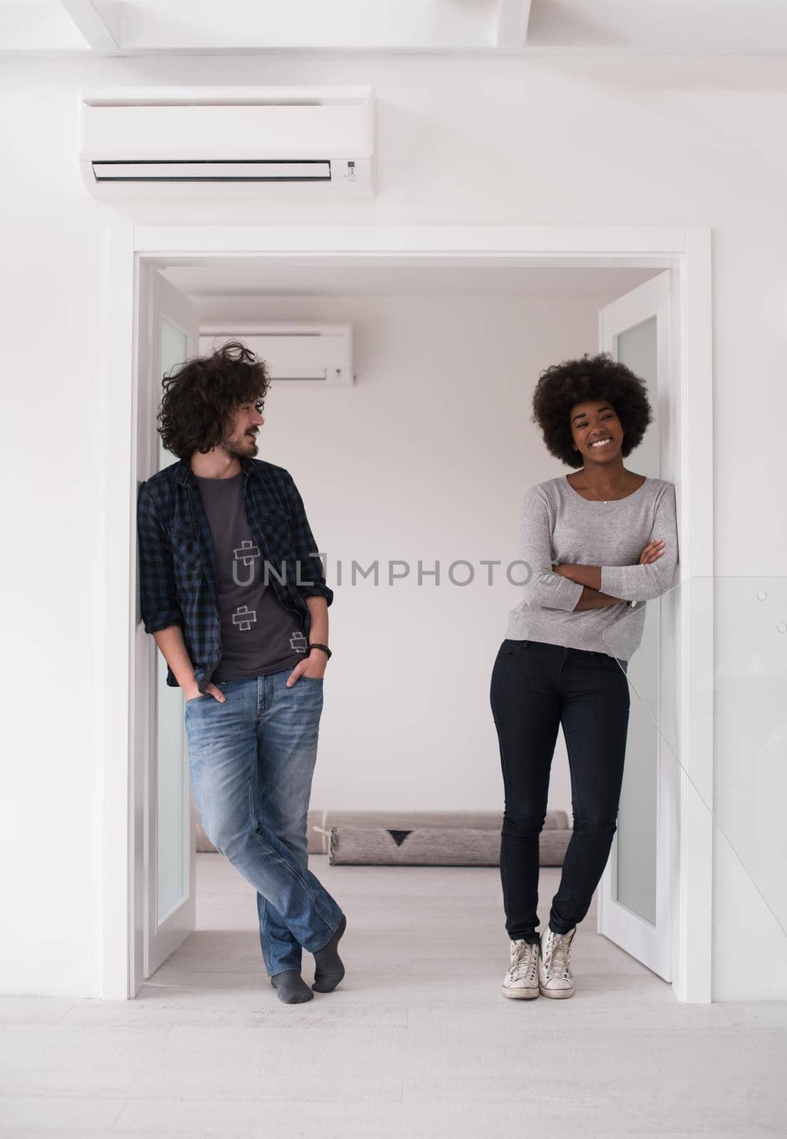 multiethnic couple renovating their home by dotshock