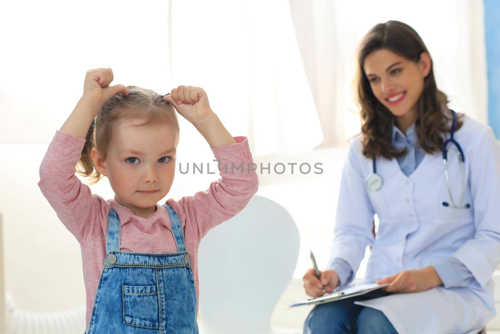 Doctor working with little patient in hospital
