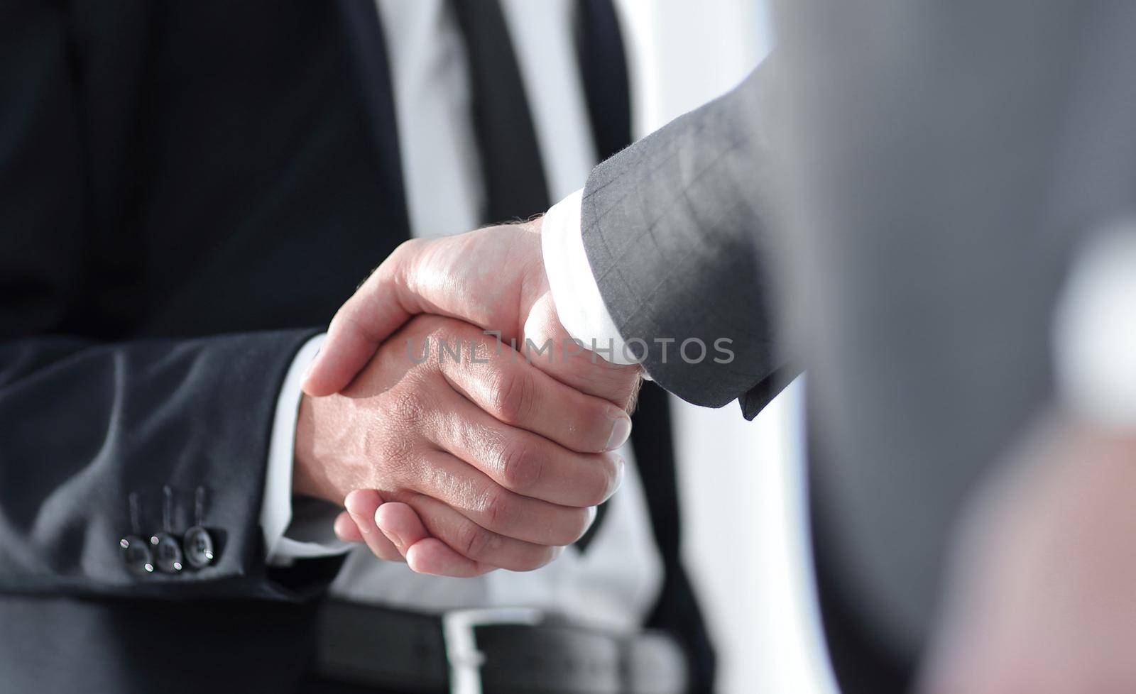 Friendly smiling businessmen handshaking. Business concept photo by asdf