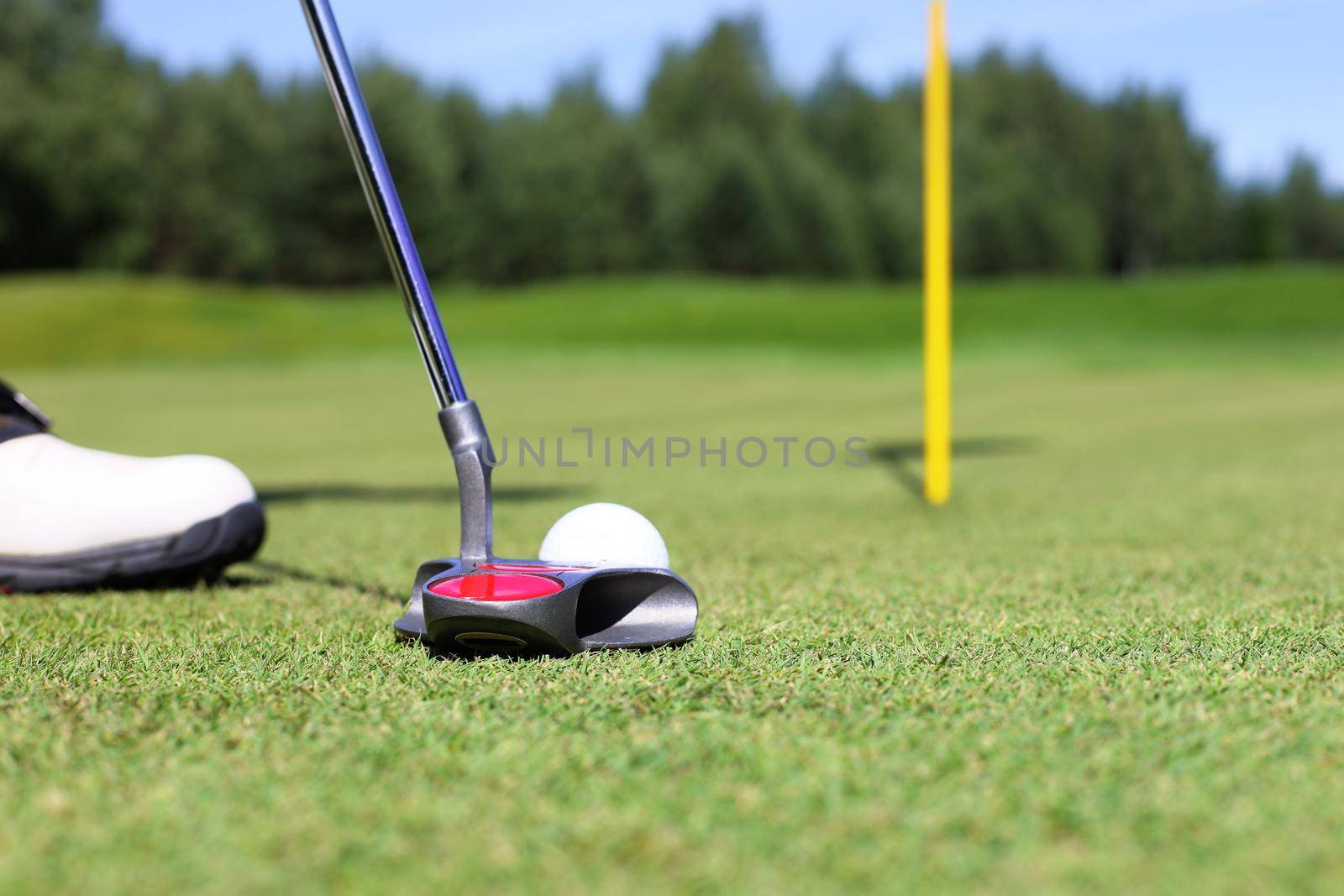 Golf club and ball. Preparing to shot