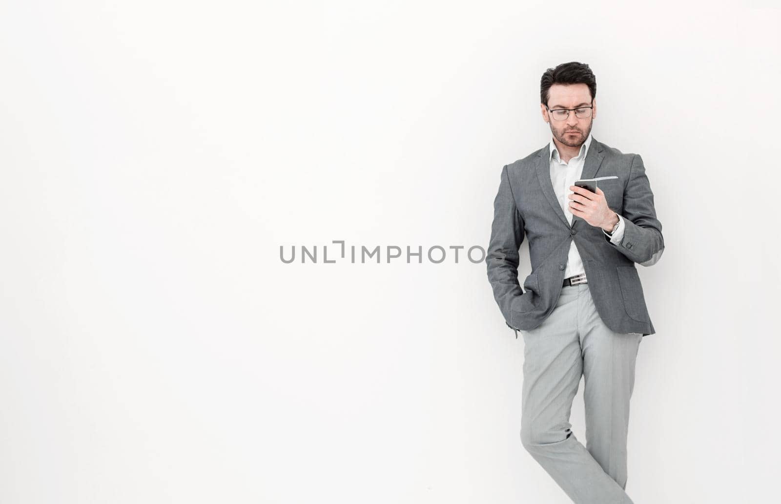 full height .business man looking at the screen of his smartphone by asdf