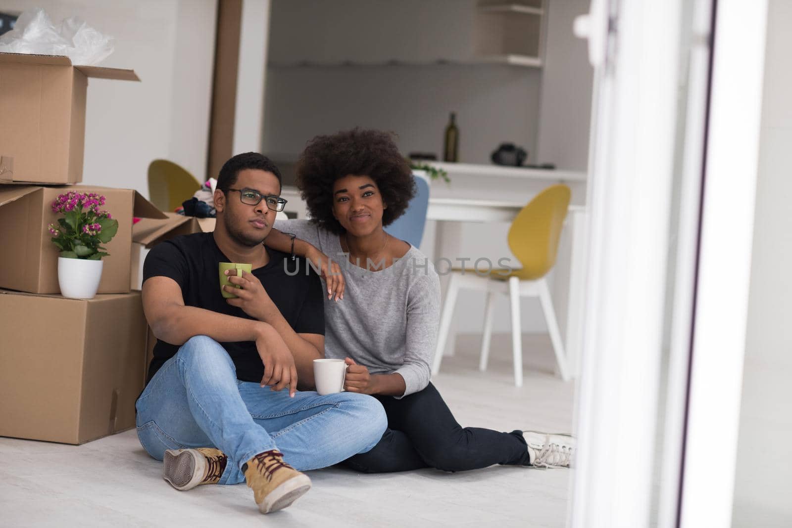 African American couple relaxing in new house by dotshock