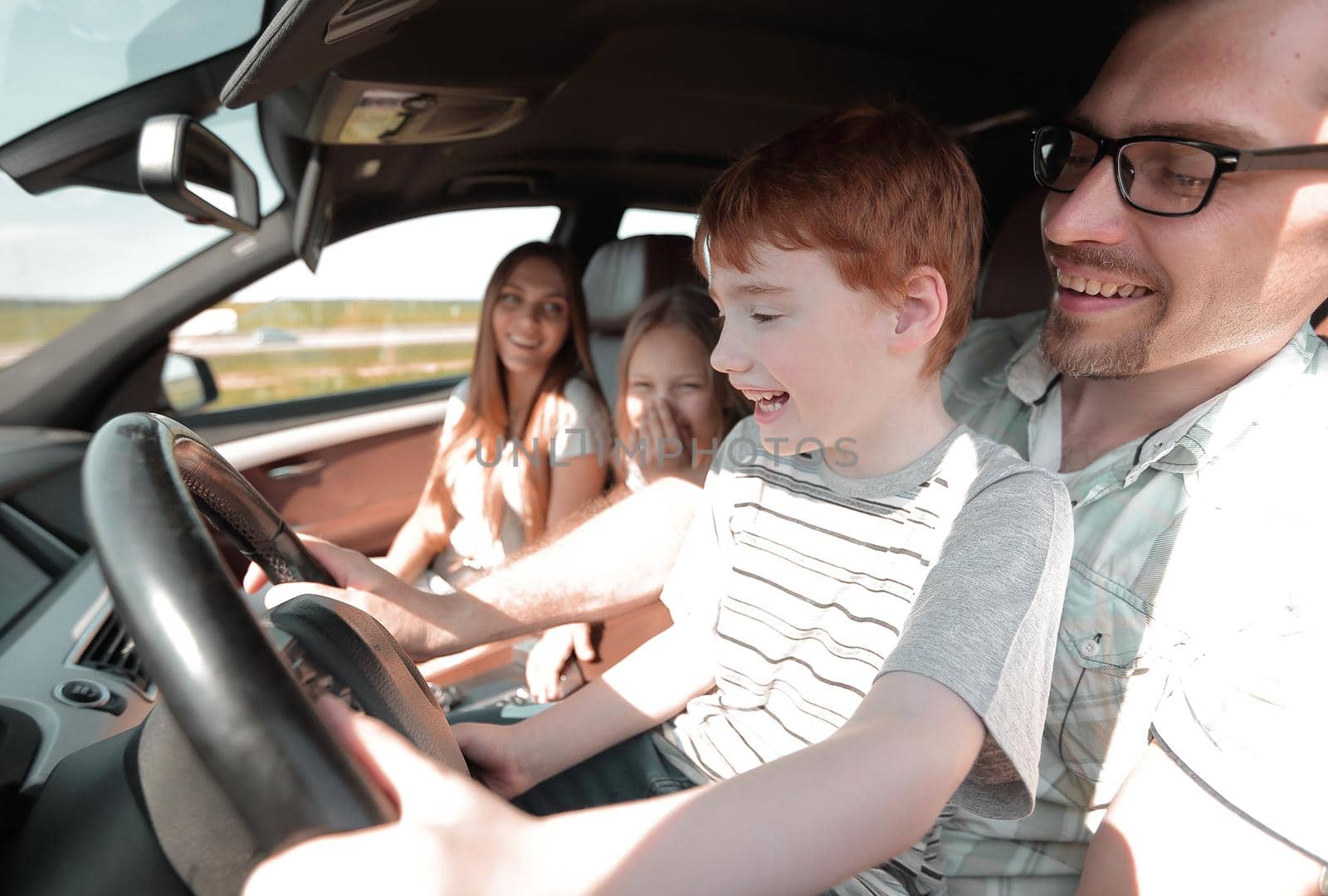 funny father and his little son driving a car .the concept of parenting