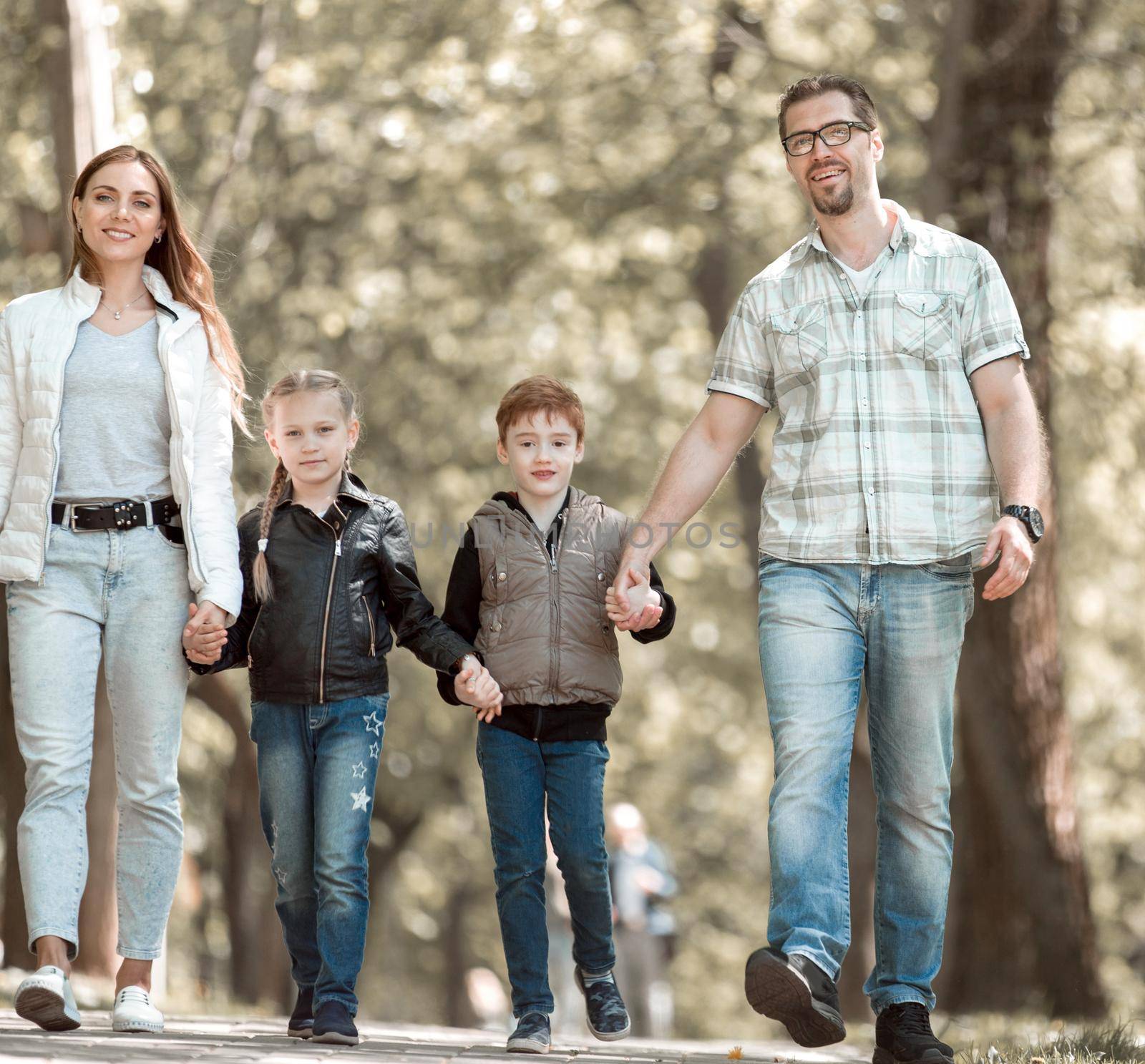 family with two children on a walk in the Park. lifestyle