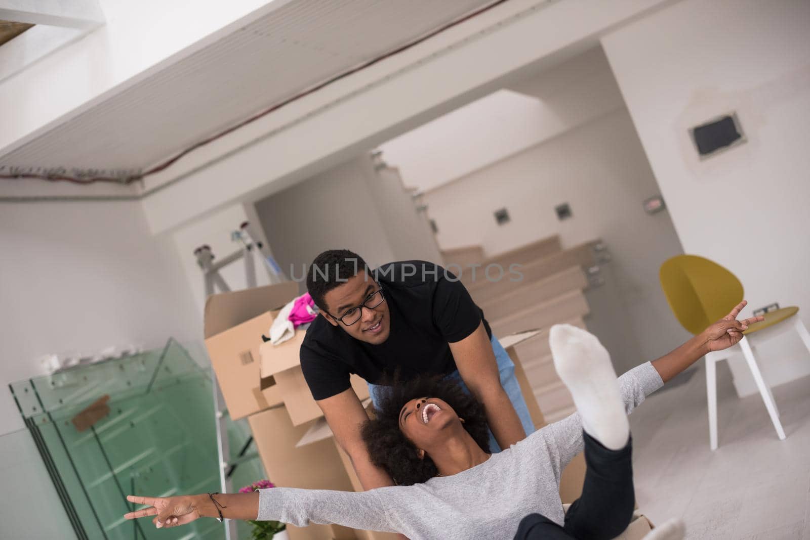 African American couple  playing with packing material by dotshock