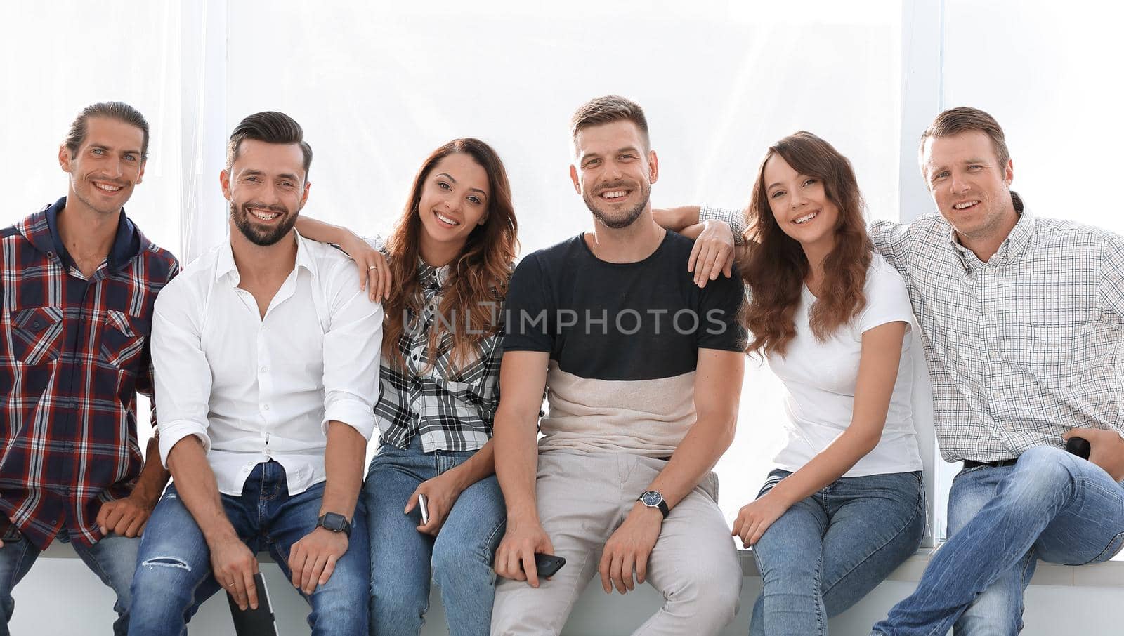 successful young employees sitting on the windowsill.photo with copy space