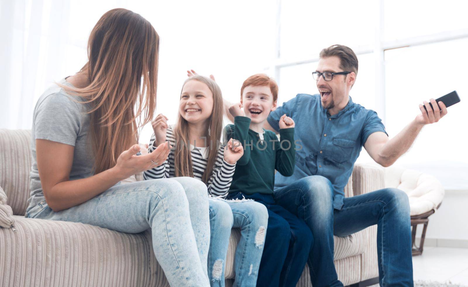 happy family sitting watching TV in their home.photo with copy space