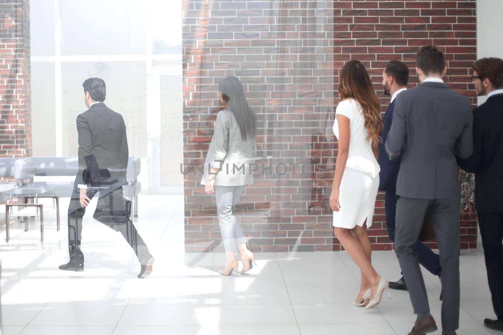 employees walking through the office hall by asdf
