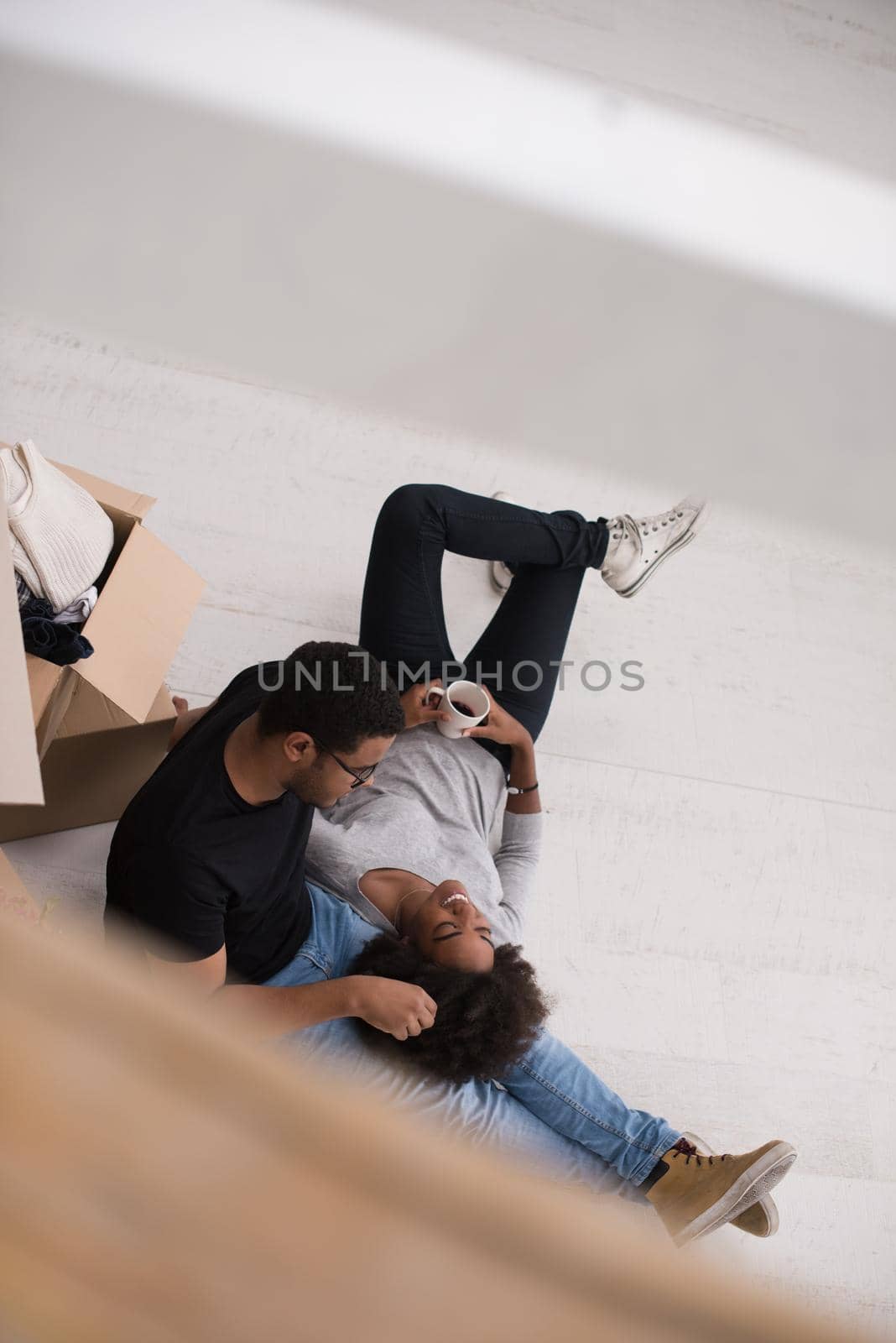 African American couple relaxing in new house by dotshock