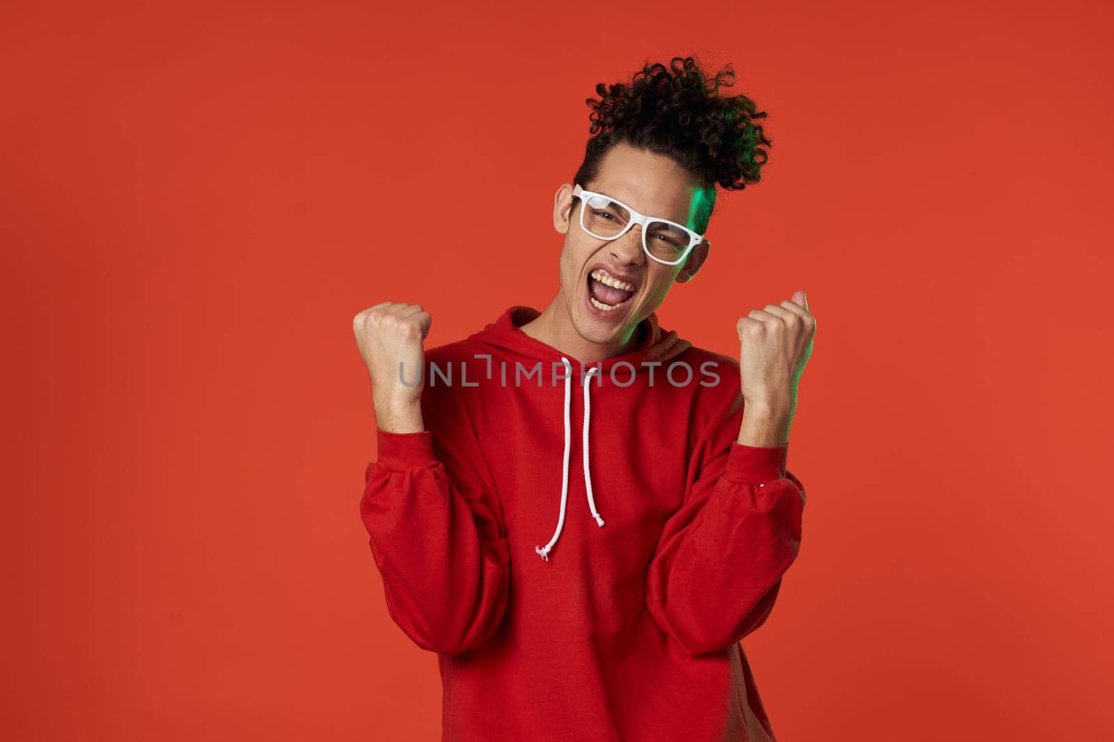 guy in red sweater posing heart holiday isolated background. High quality photo