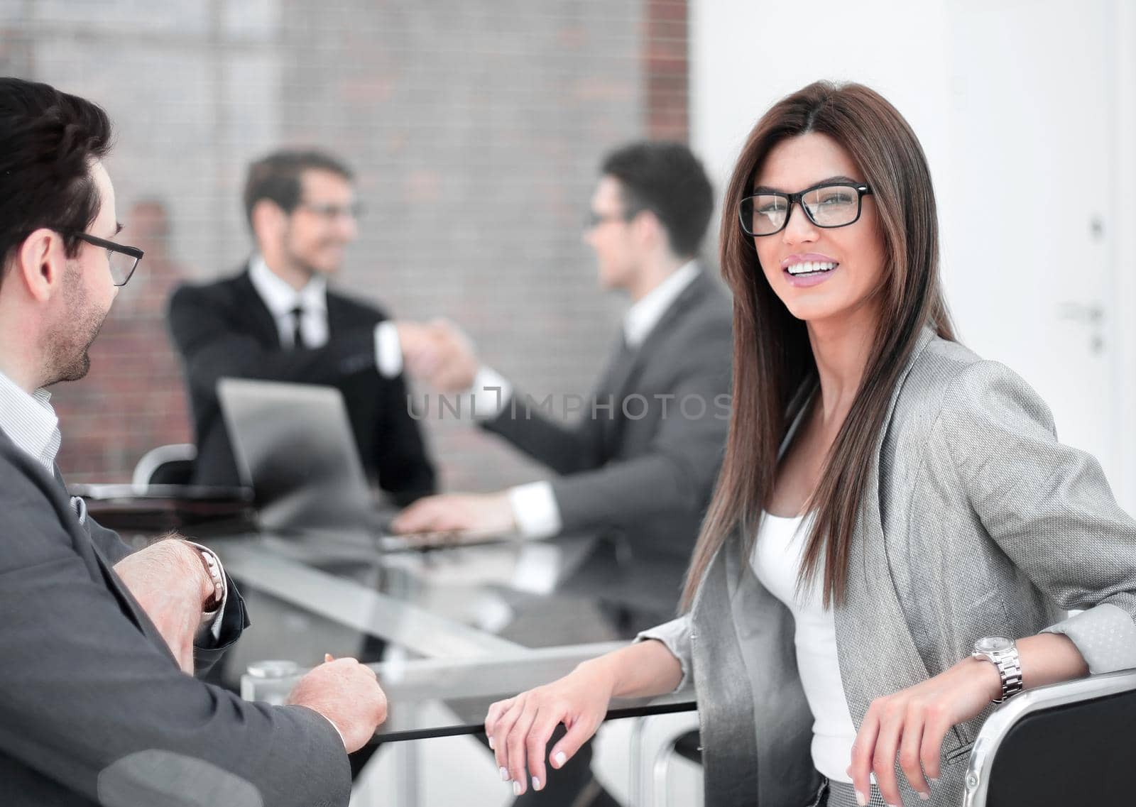 businessman and business woman sitting at the negotiating table by asdf