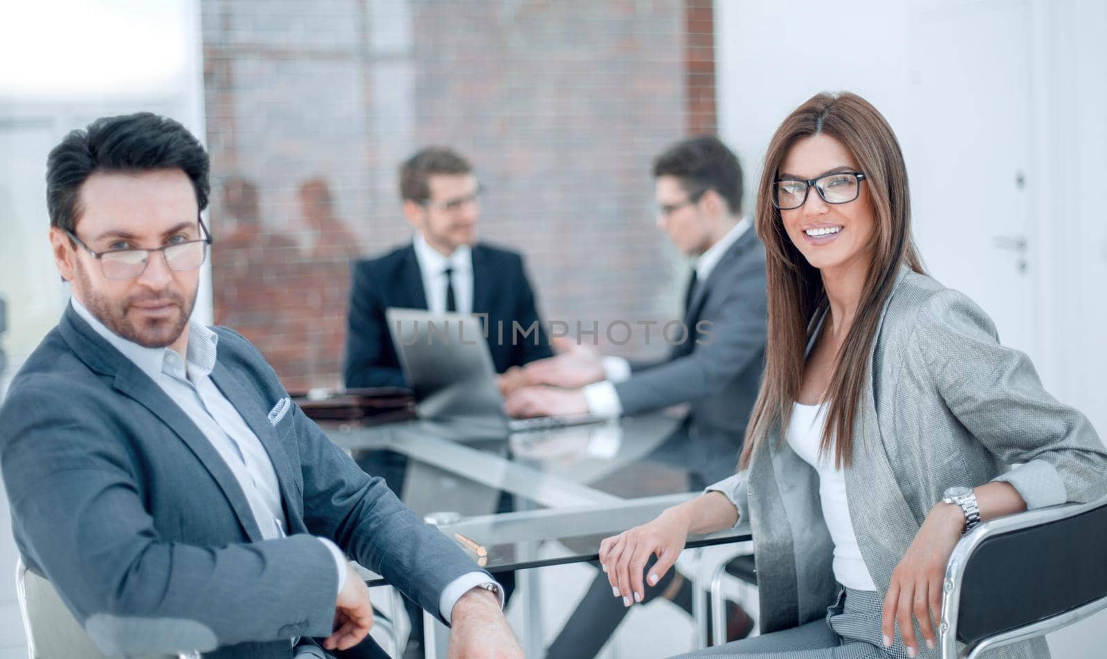 businessman and business woman sitting at the Desk.business concept