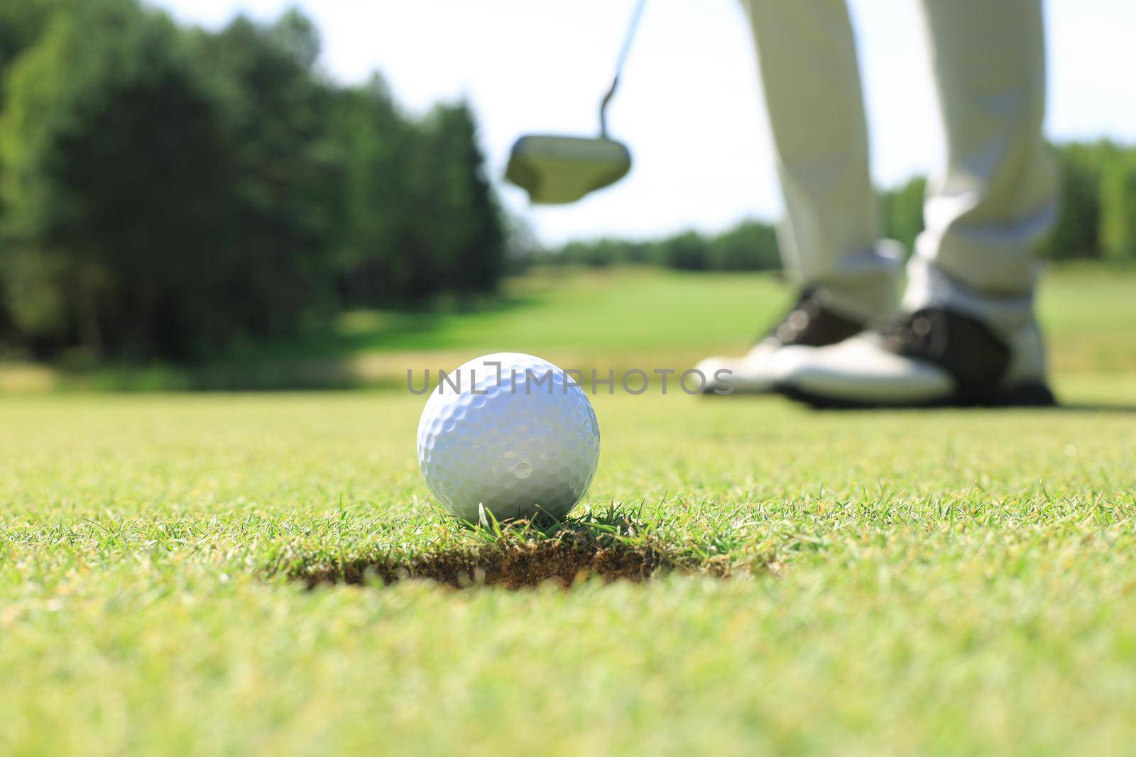 Golf club and ball. Preparing to shot