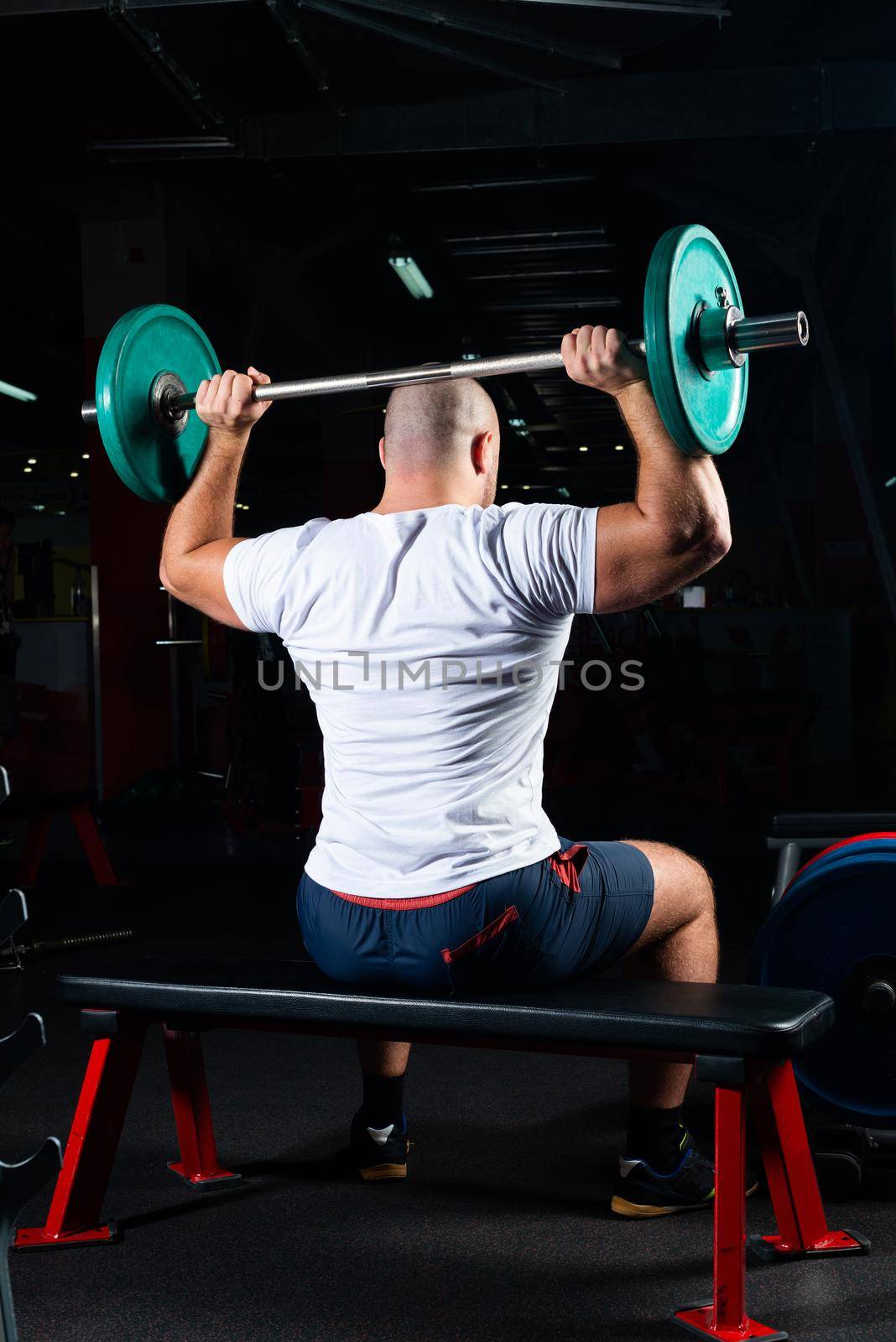 Male athlete lifts the barbell by adam121