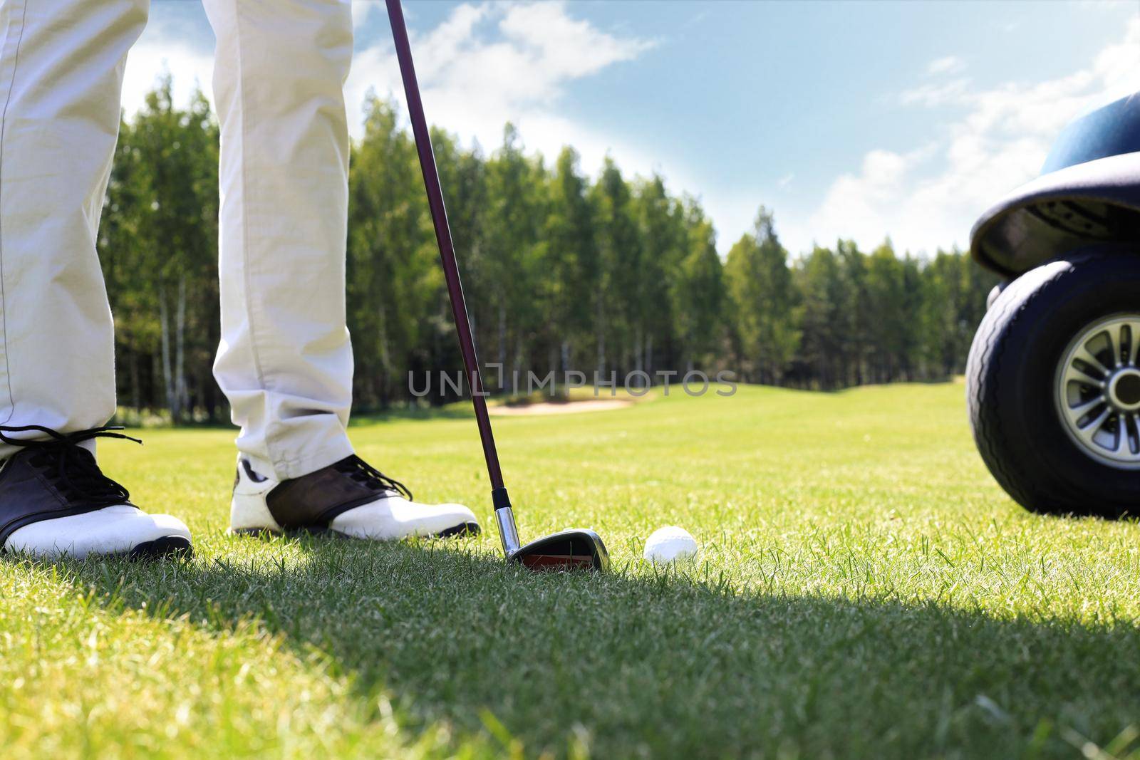 Golf approach shot with iron from fairway at sunny day. by tsyhun