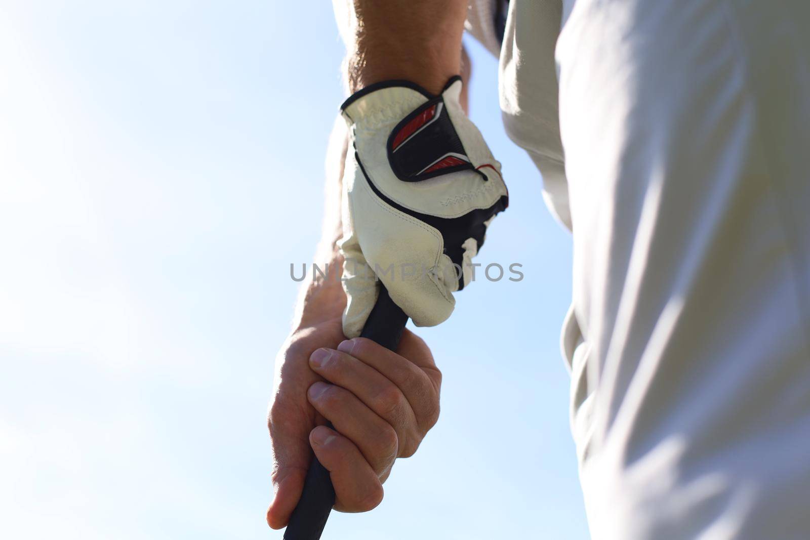 Golfer wearing a golf holding a putter