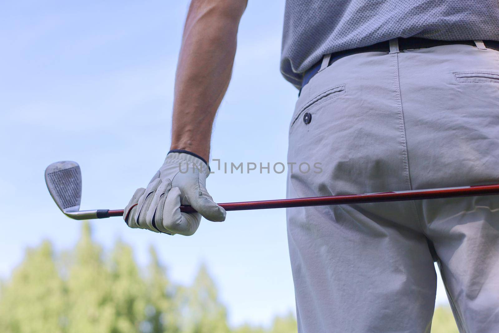 Golf approach shot with iron from fairway at sunny day. by tsyhun