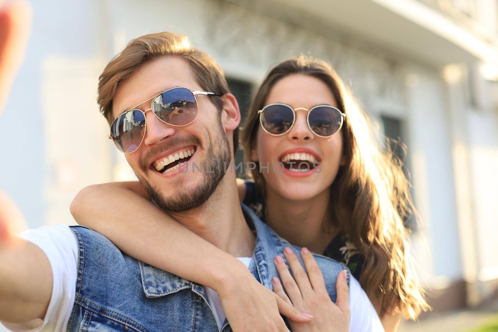 Beautiful young couple in love walking outdoors at the city street