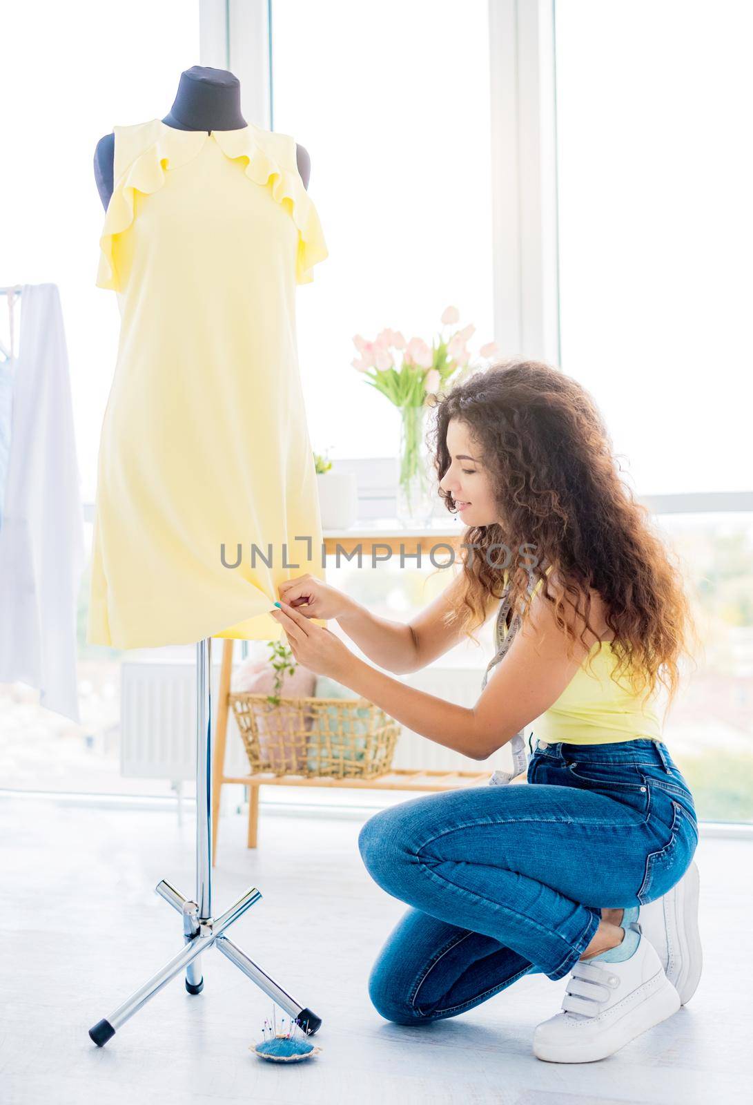 Needlewoman sewing the edge of dress by GekaSkr