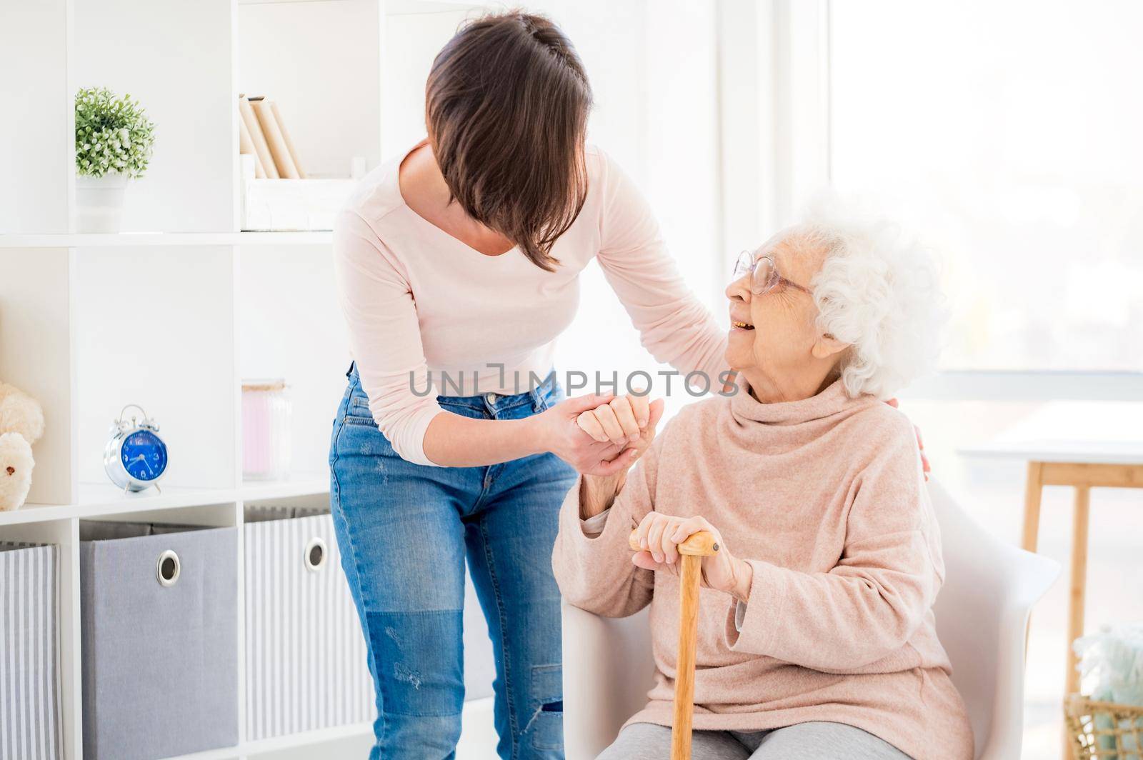 Woman helping lovely old lady by GekaSkr