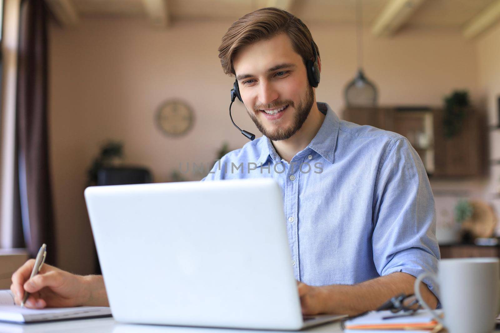 Freelance operator talking with headsets and consulting clients from home office