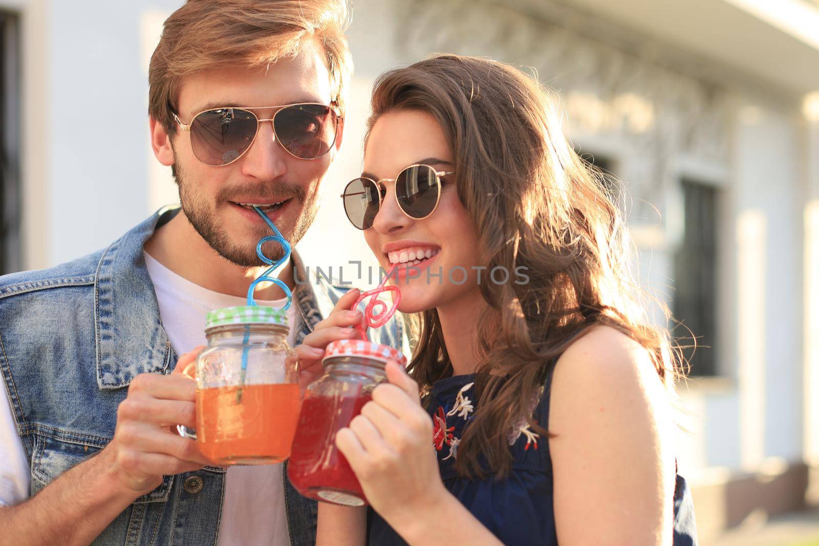 Beautiful young couple in love walking outdoors at the city street