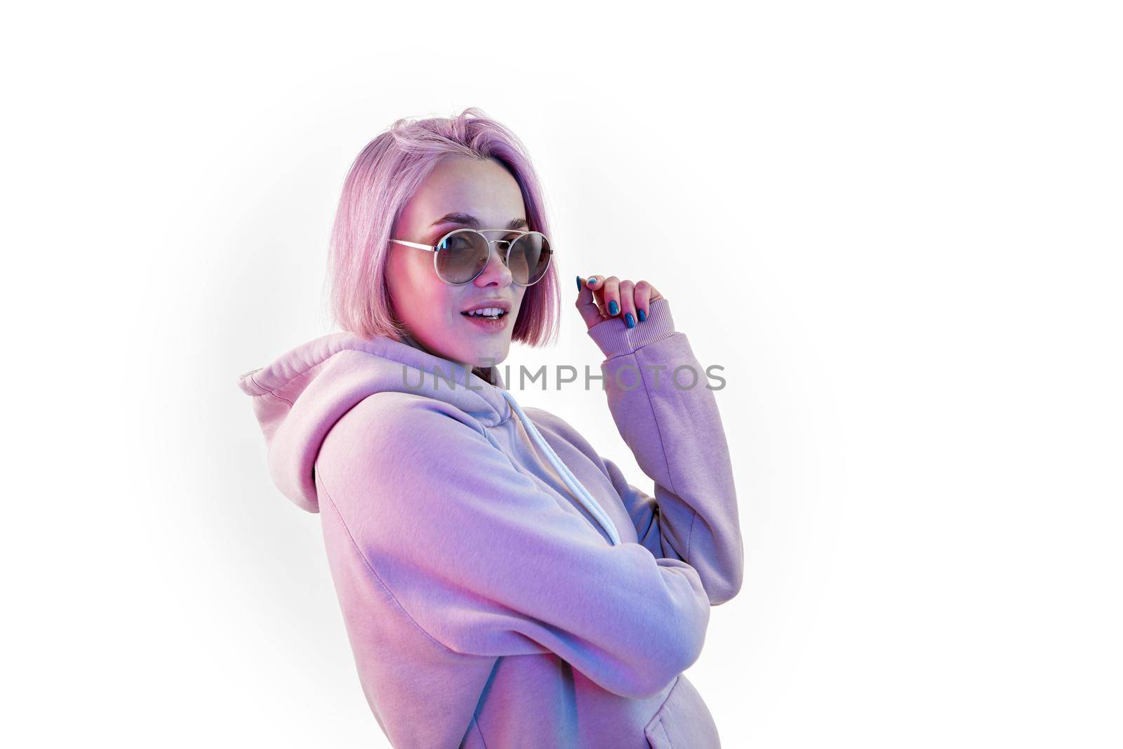 Fashion portrait of beauty young woman with pink bob hairstyle holding on to sunglasses blue nail polish manicure on white background