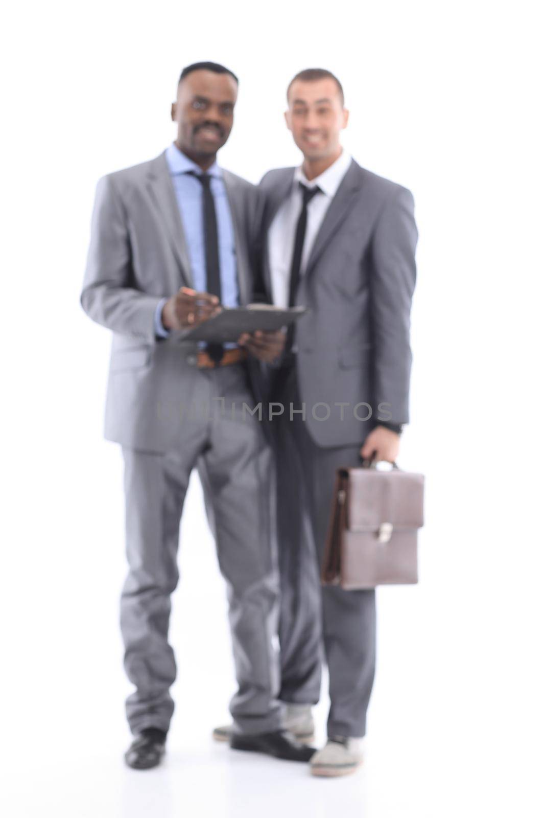 Blurred image of two young employees working together on a white background.