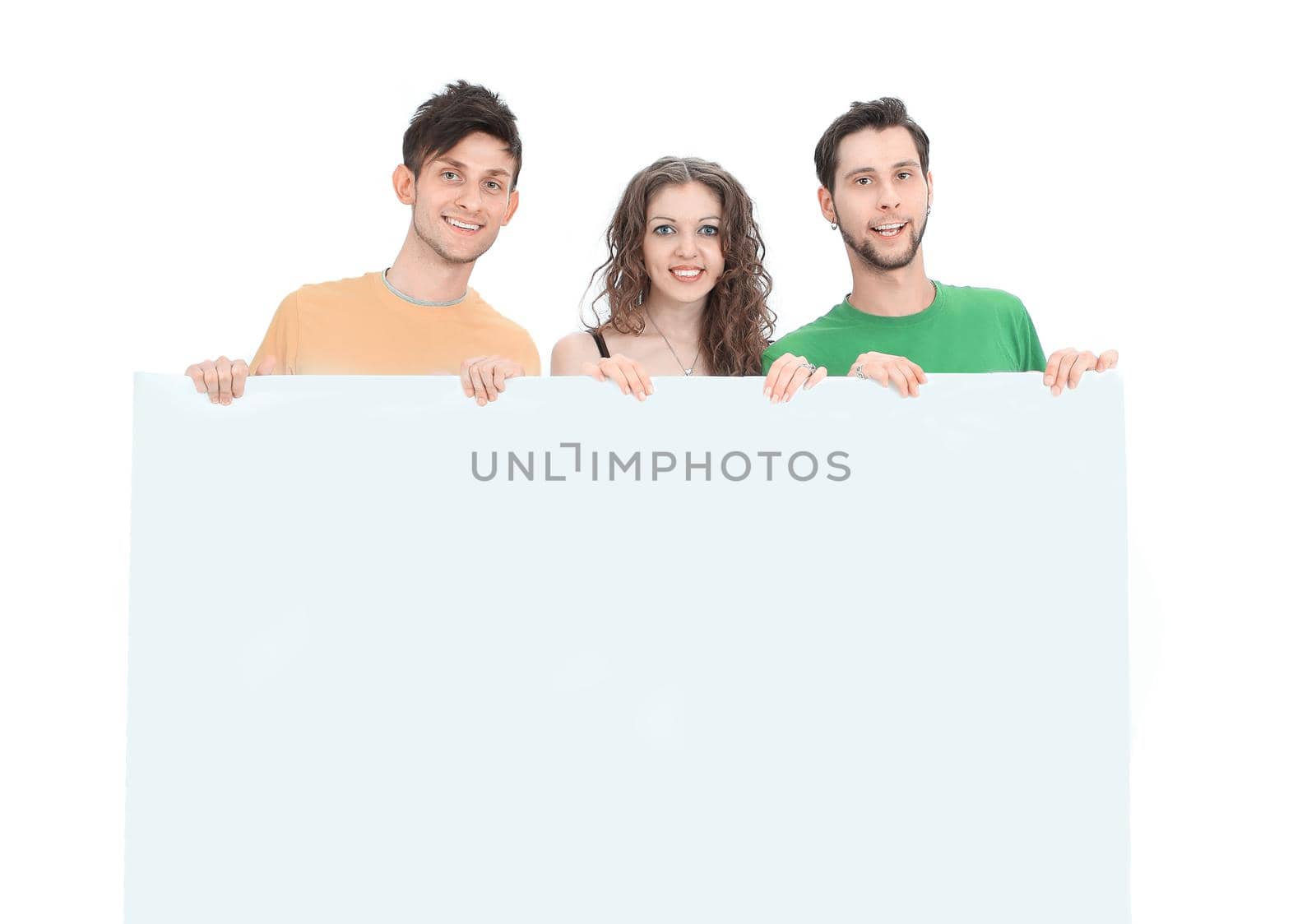 group of young people holding a large blank poster .isolated on a white background.