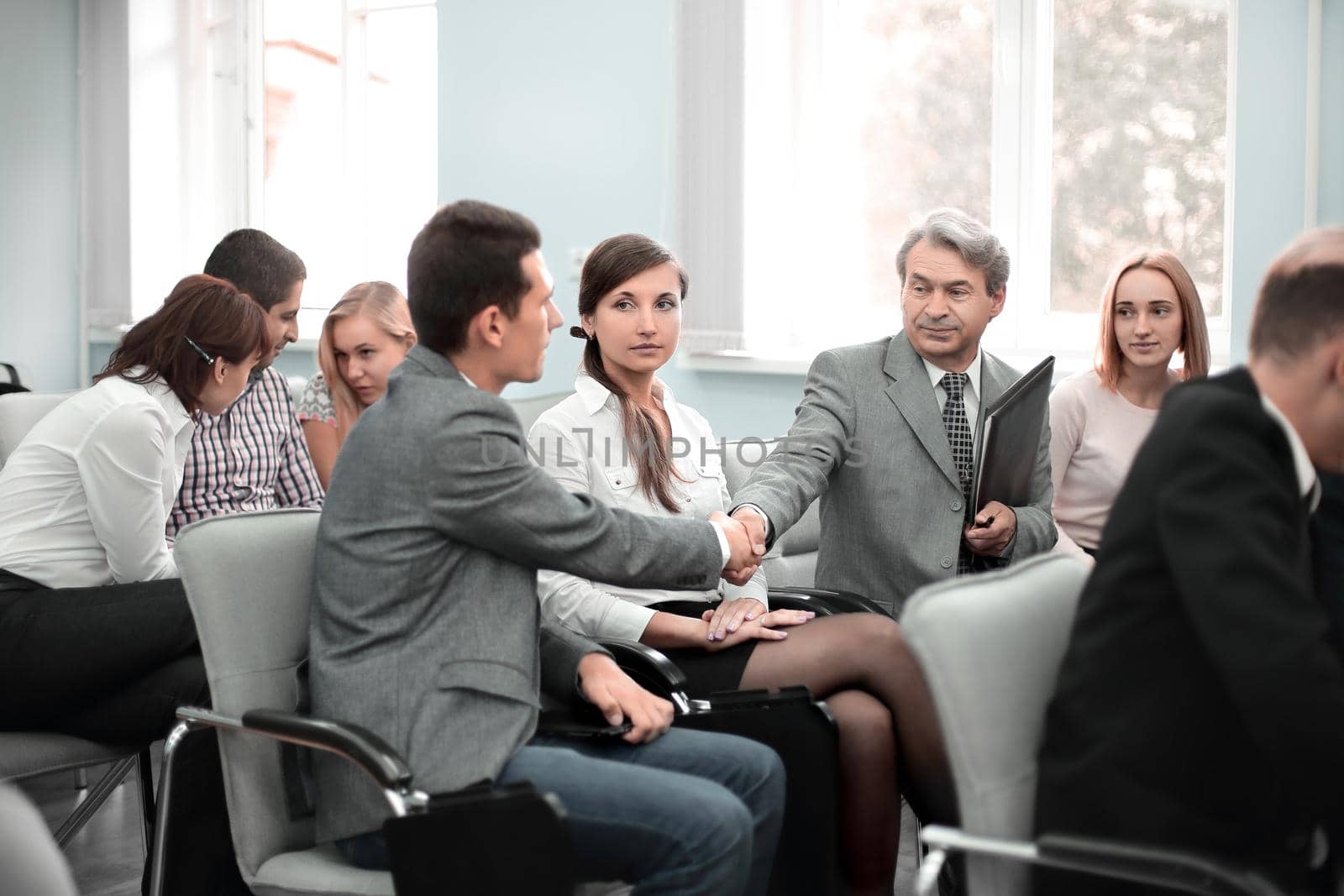 handshake colleagues in the conference room before the meeting.the concept of teamwork