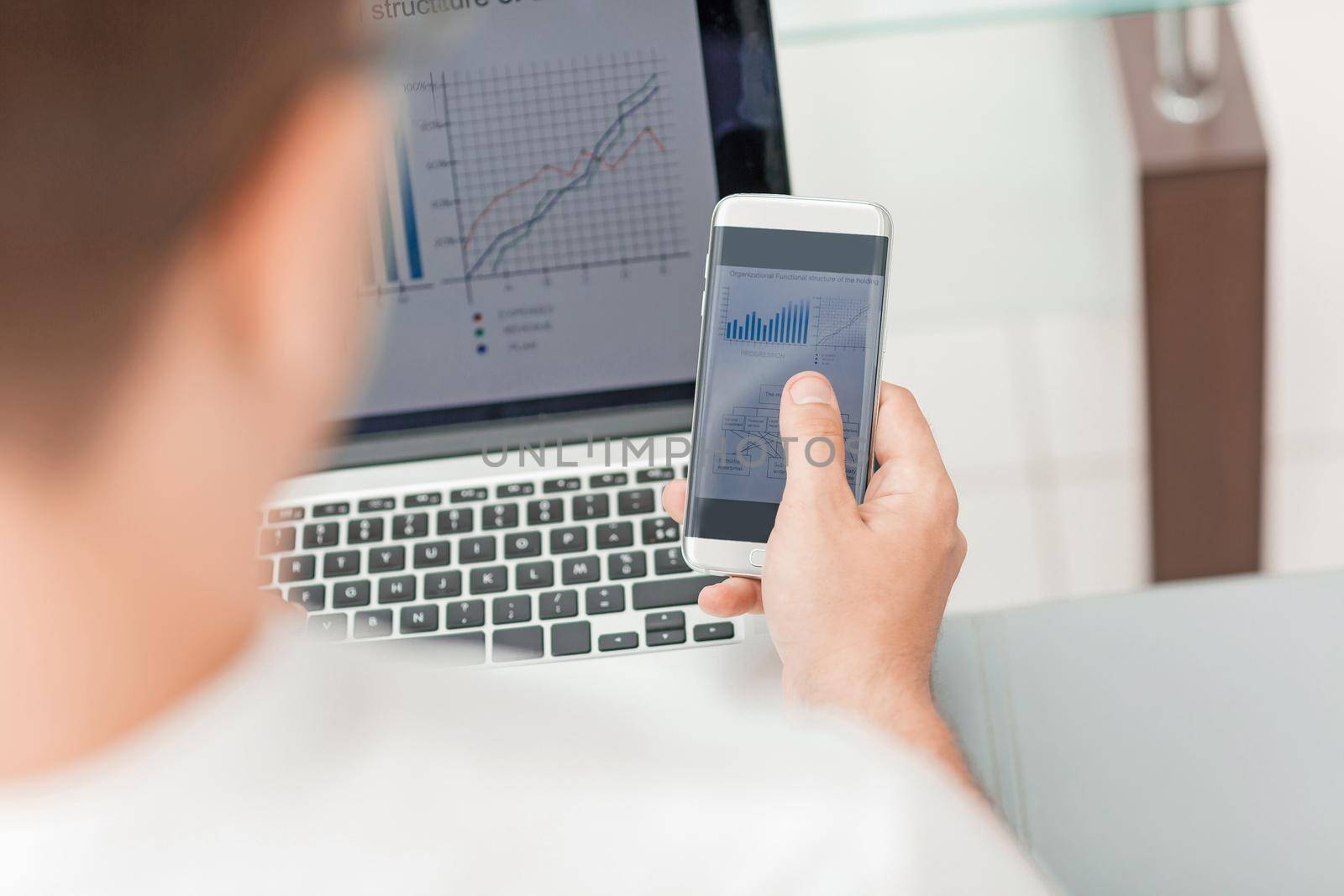 close up. businessman using gadgets for the audit of the financial report. people and technology