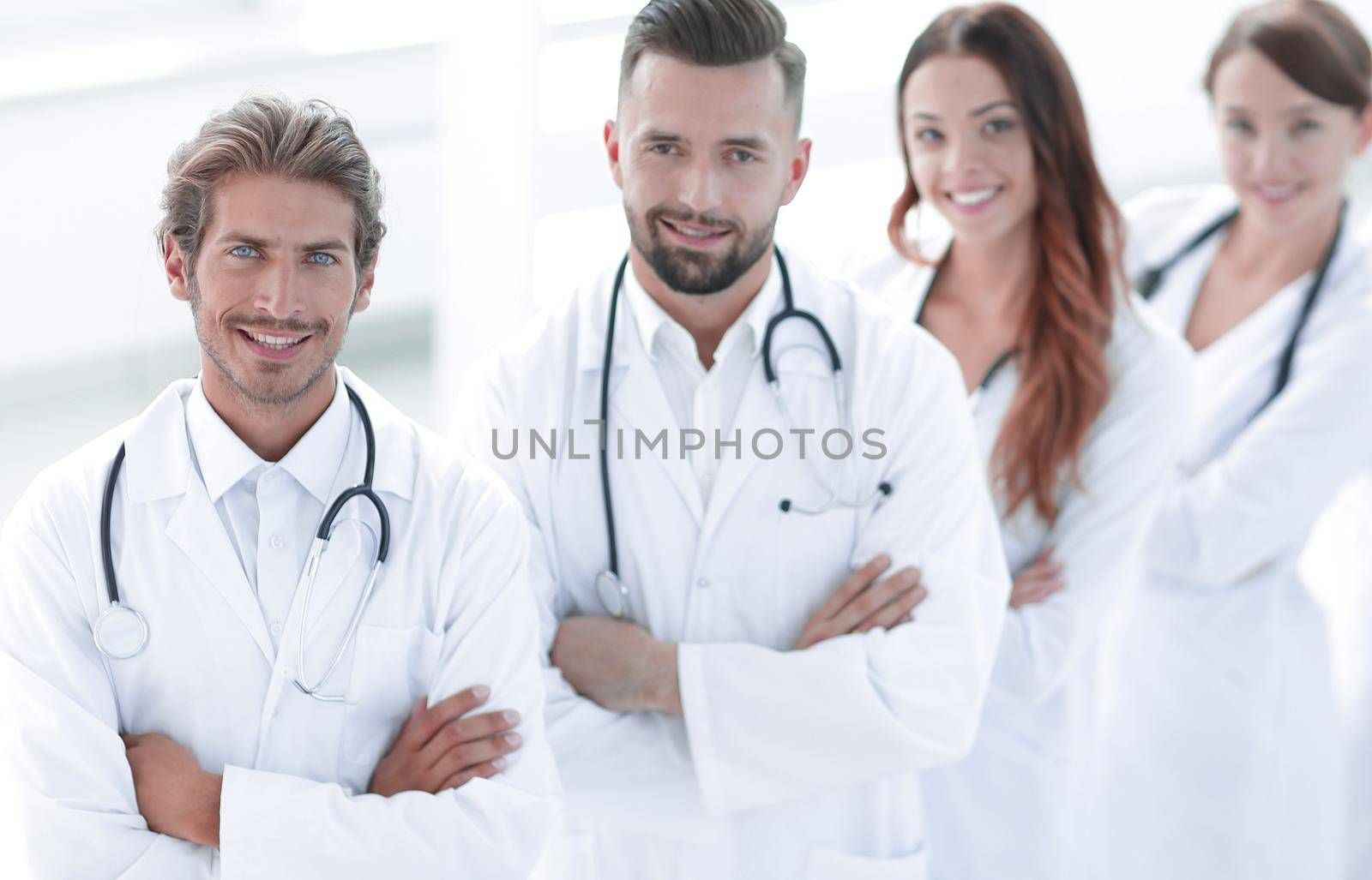 Portrait of medical team standing with arms crossed in hospital.concept of health