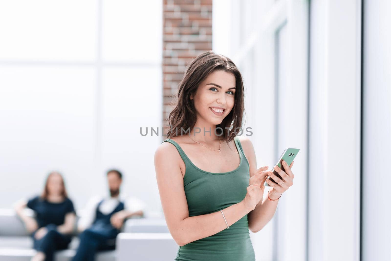 young woman reading SMS on her smartphone.photo with copy space